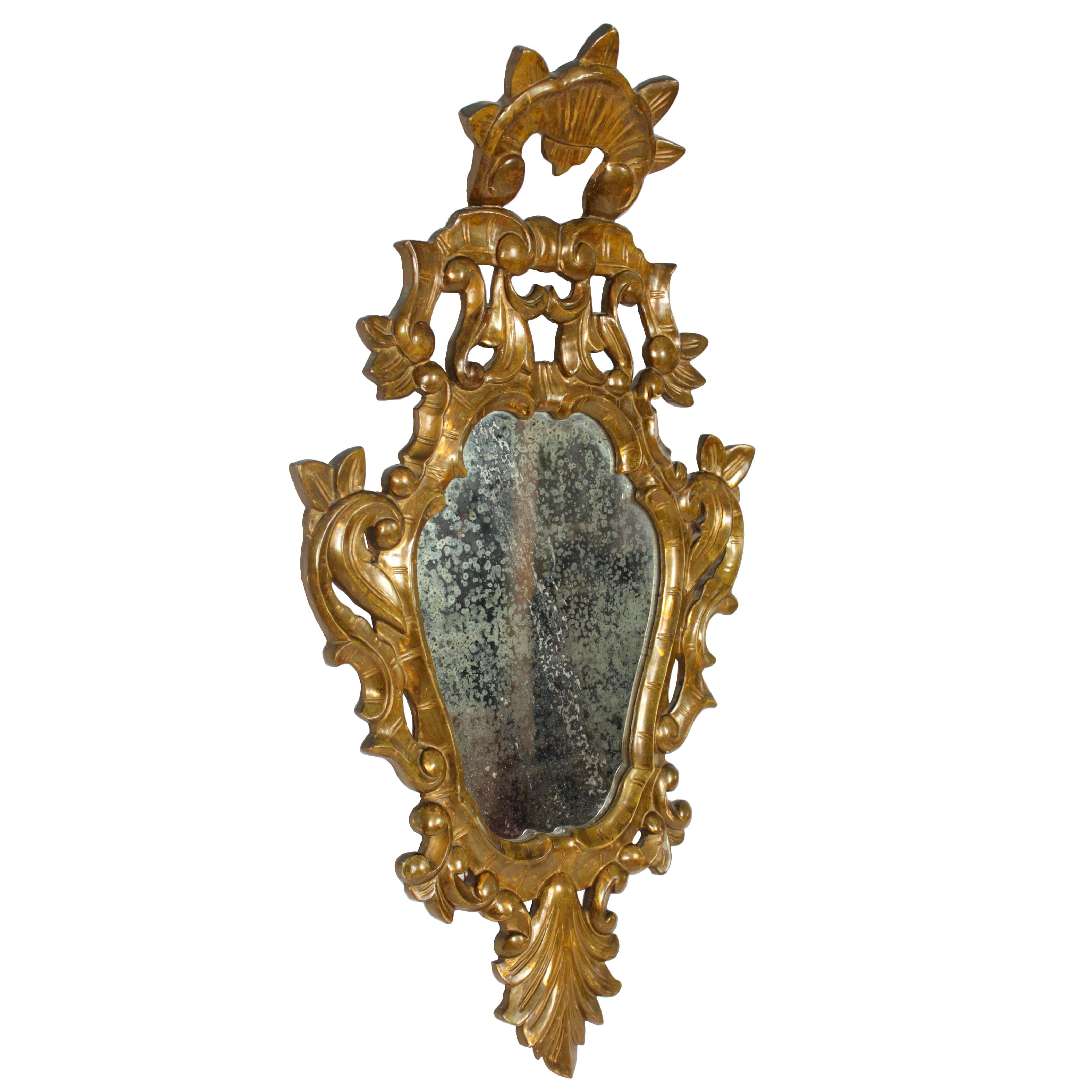 Spanish Rococo style giltwood mirror, finely carved and with a nice gold leaf patina. Spain, 19th century.
This piece wears its original mercury glass mirror. Spain, c.1890.

Avaliable more mirrors in this style and also in other styles:
Please