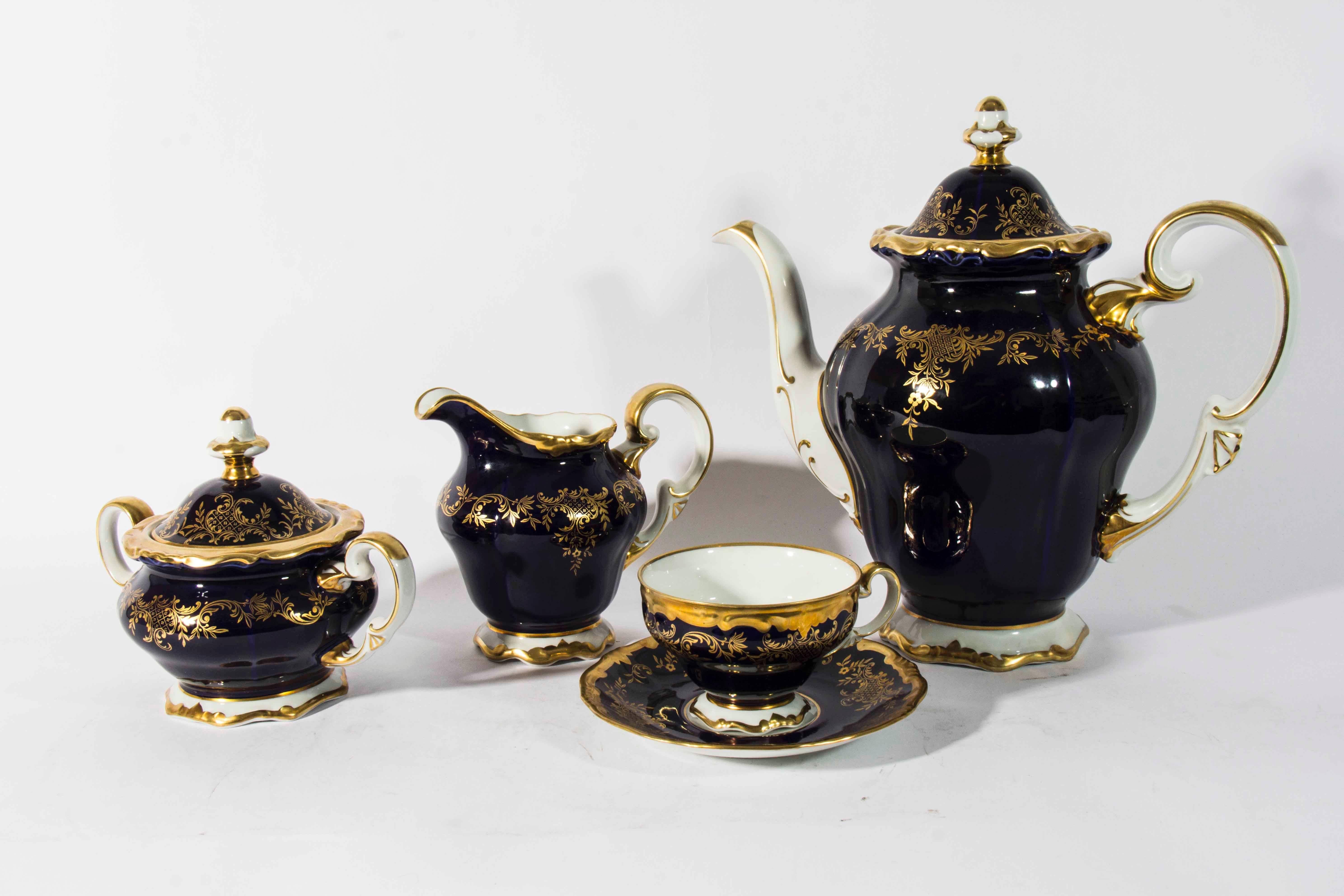 Vintage 1940s cobalt with gold trim design complete service for eight with extra pieces available. From Weimar Germany. Total count of 86 pieces.

Eight cups and saucers.
Eight dinner plates.
Eight salad plates.
Eight bread and butter
