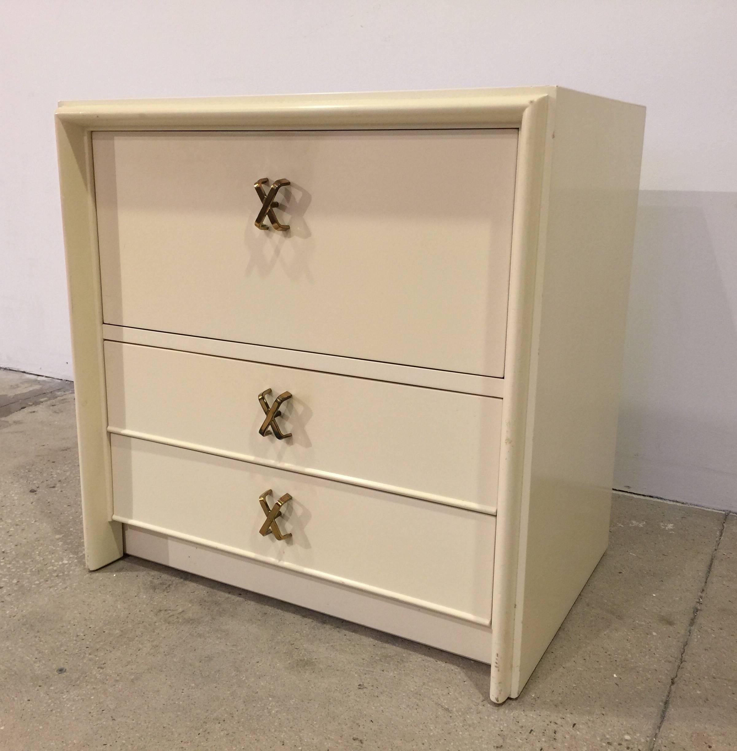 Pair of mahogany nightstands in white satin lacquer finish with polished brass 