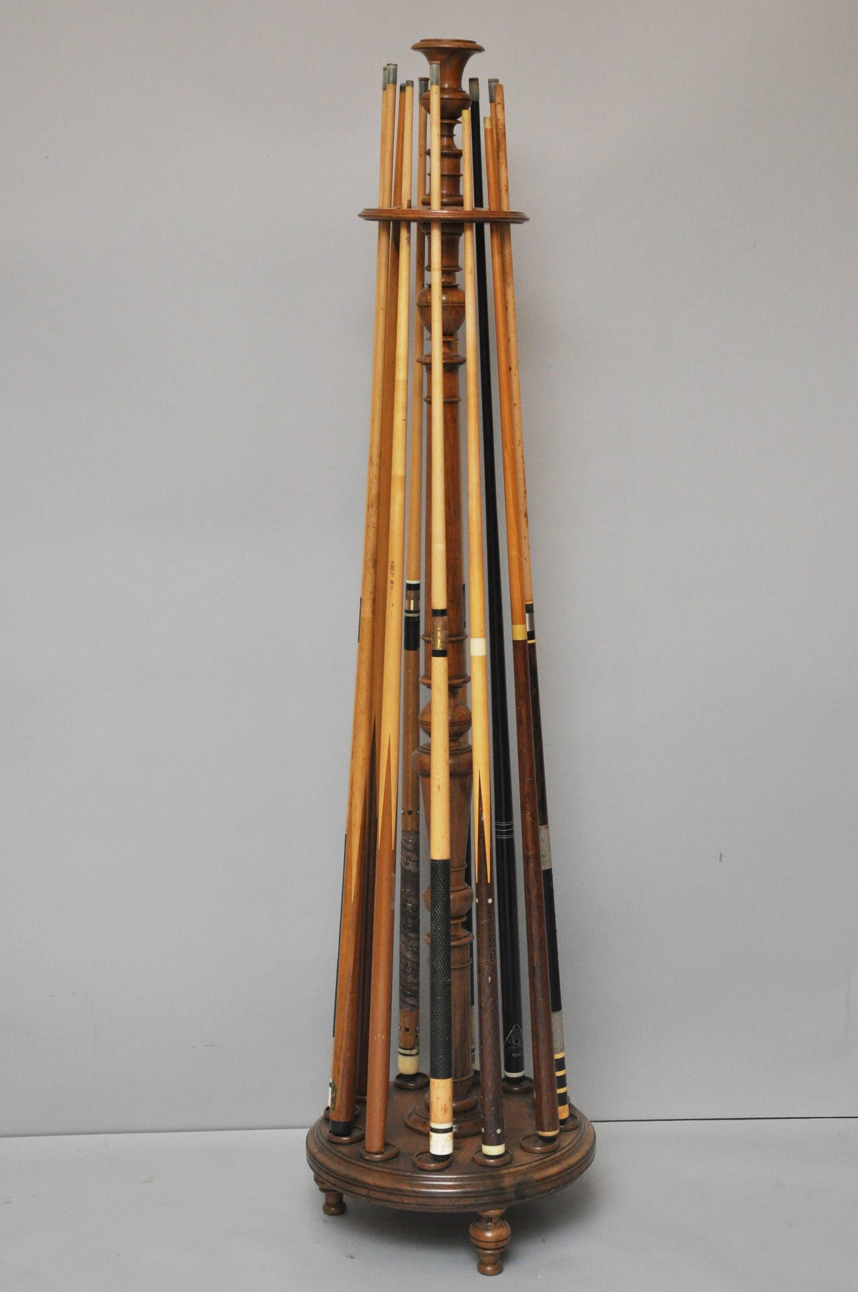 19th century French snooker or billiards cue stand. Free standing frame holds up to 12 cues, circular platform contains round inserts to hold cues in place, rests on three turned bulbous feet. Top shelf supports an epergne used to hold chalk.
    