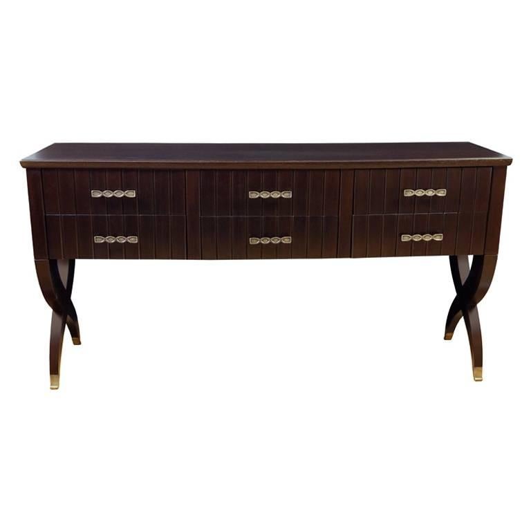 Italian 1940s credenza, Italy, circa 1945.

Rich brown stained oak credenza with six drawers, metal pulls and sabots.
The distinctive leg design of this cabinet appears on cabinets and desks by both Paolo Buffa and Tomaso Buzzi. As we have found