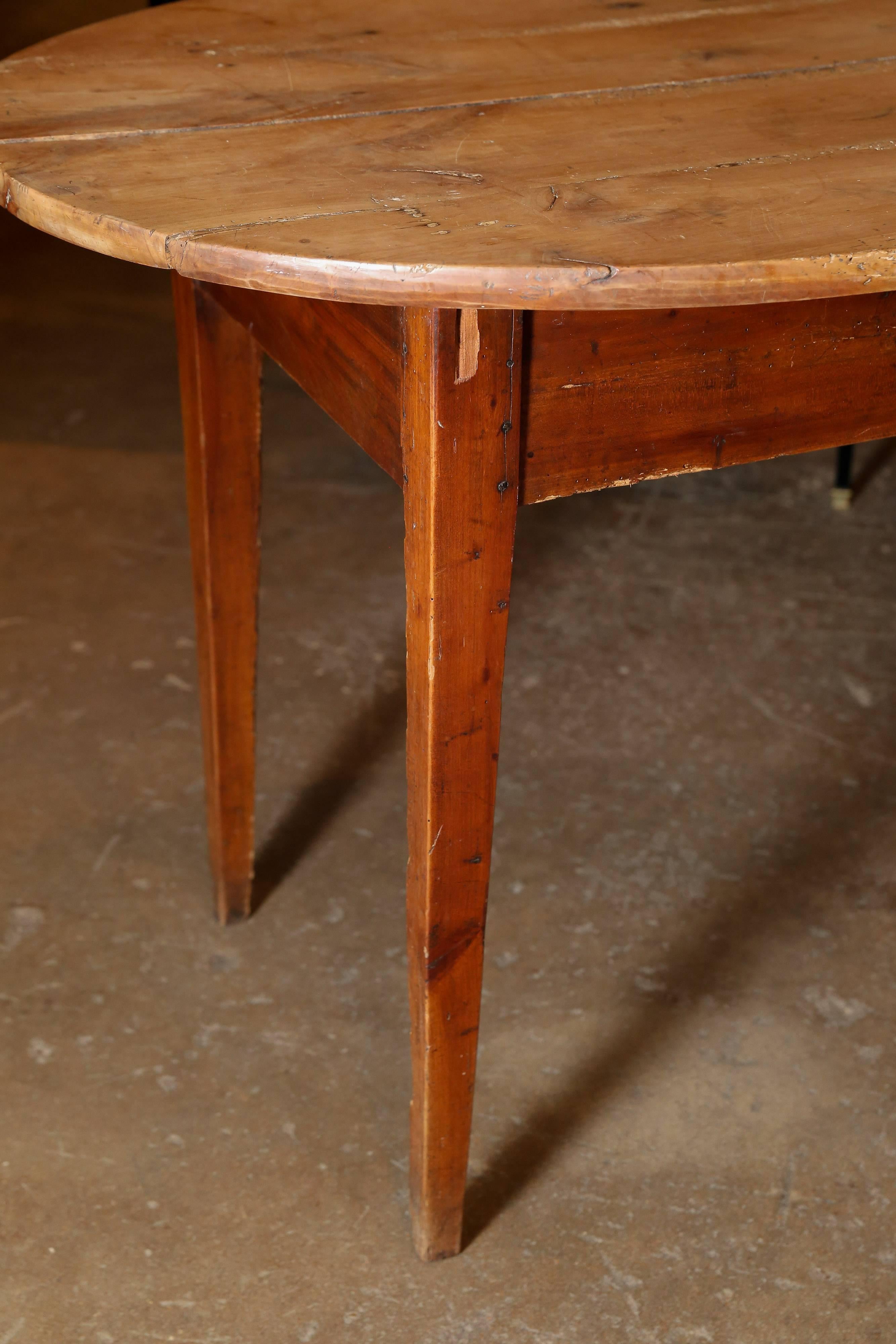 Rustic cherry oval table with darker base and sun bleached top. Clean simple lines.