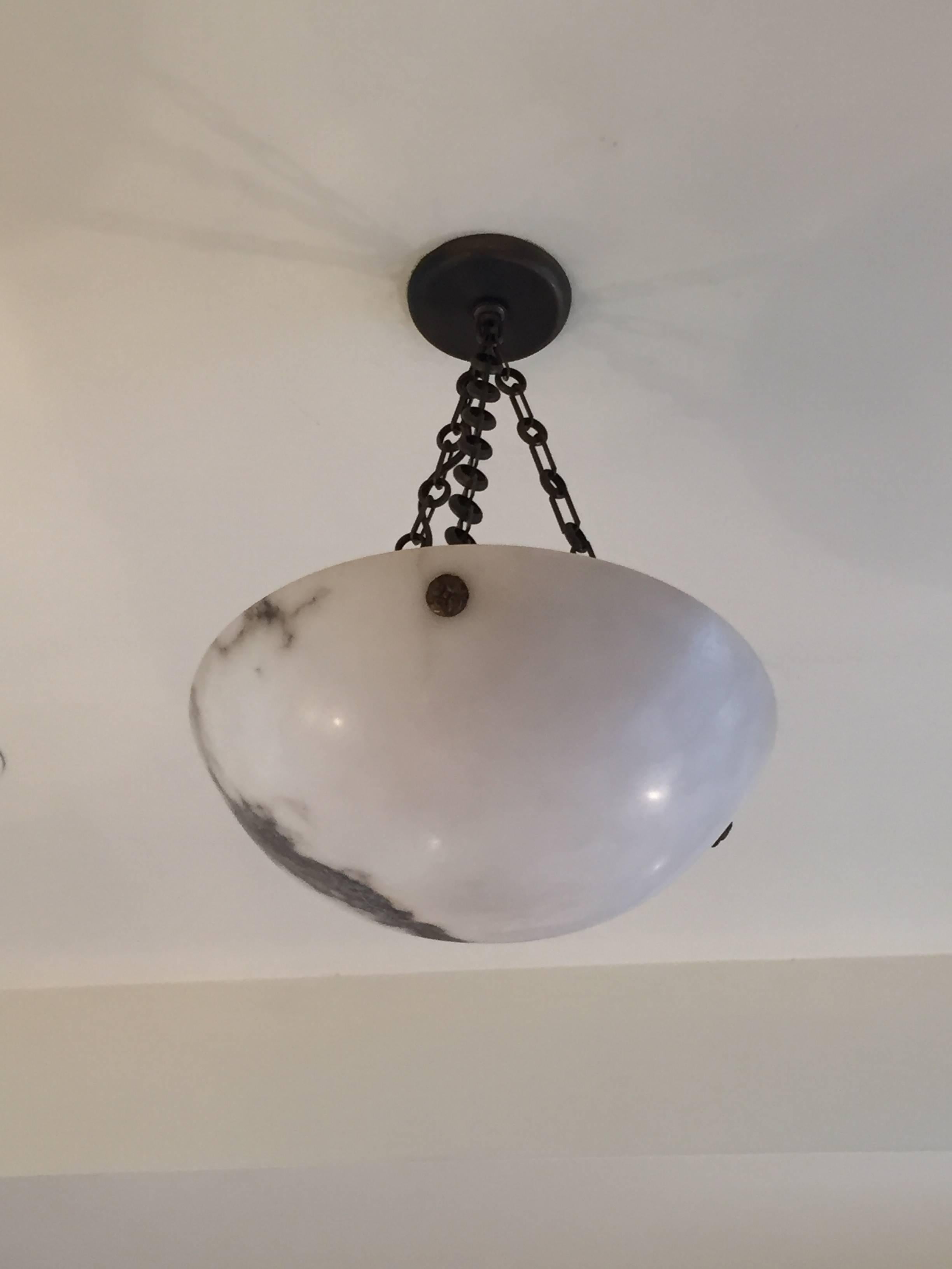 Alabaster chandelier with bronze medallions.