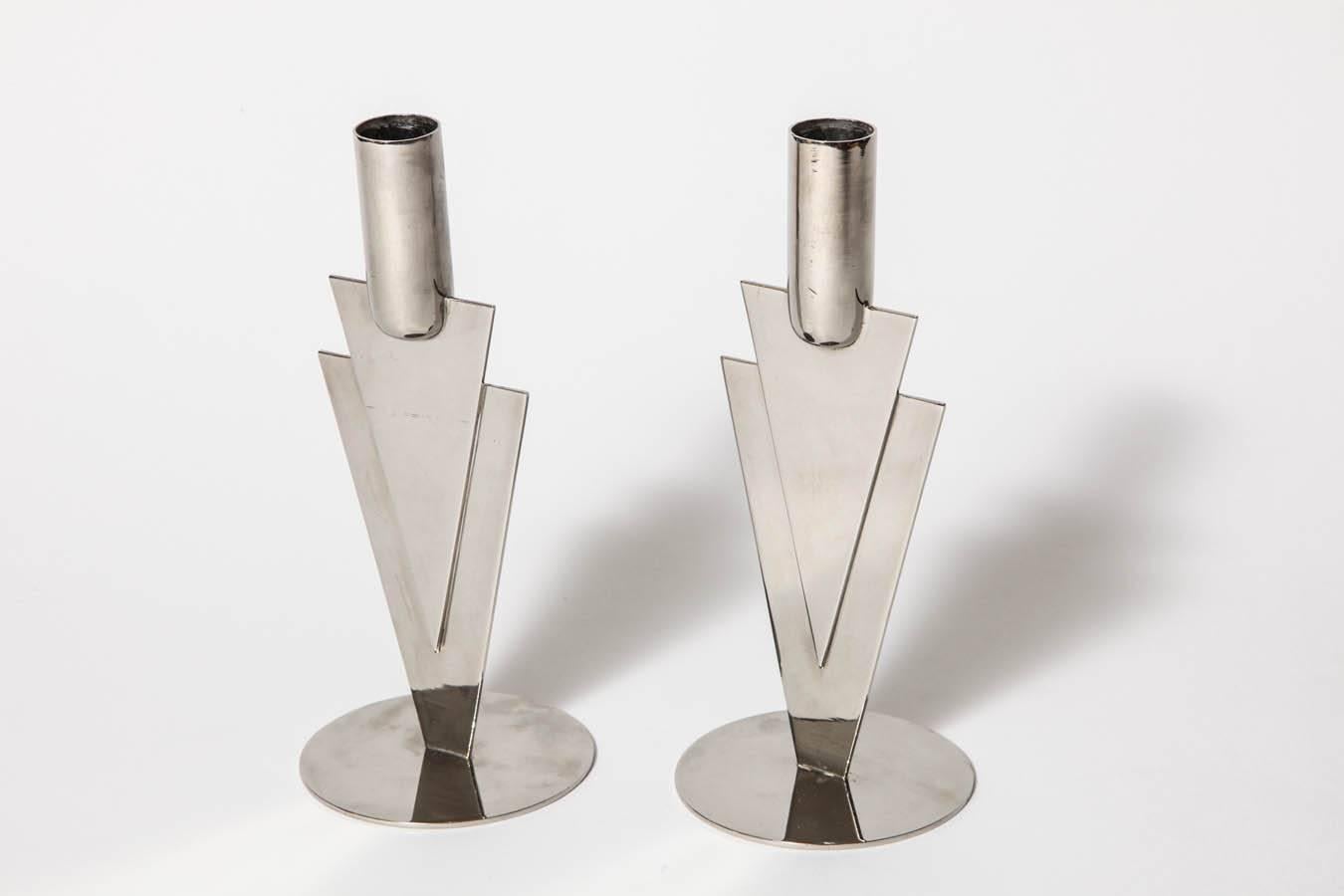 A Nickel Plated Brass Pair of Stylized Arrow Hagenauer Werkstätte Candlesticks designed by Karl Hagenauer, circa 1928. Original Finish in Mint Condition.
underside of base marked with WHW (Werkstätte Hagenauer Wien), 
HagenauerWien, Made in