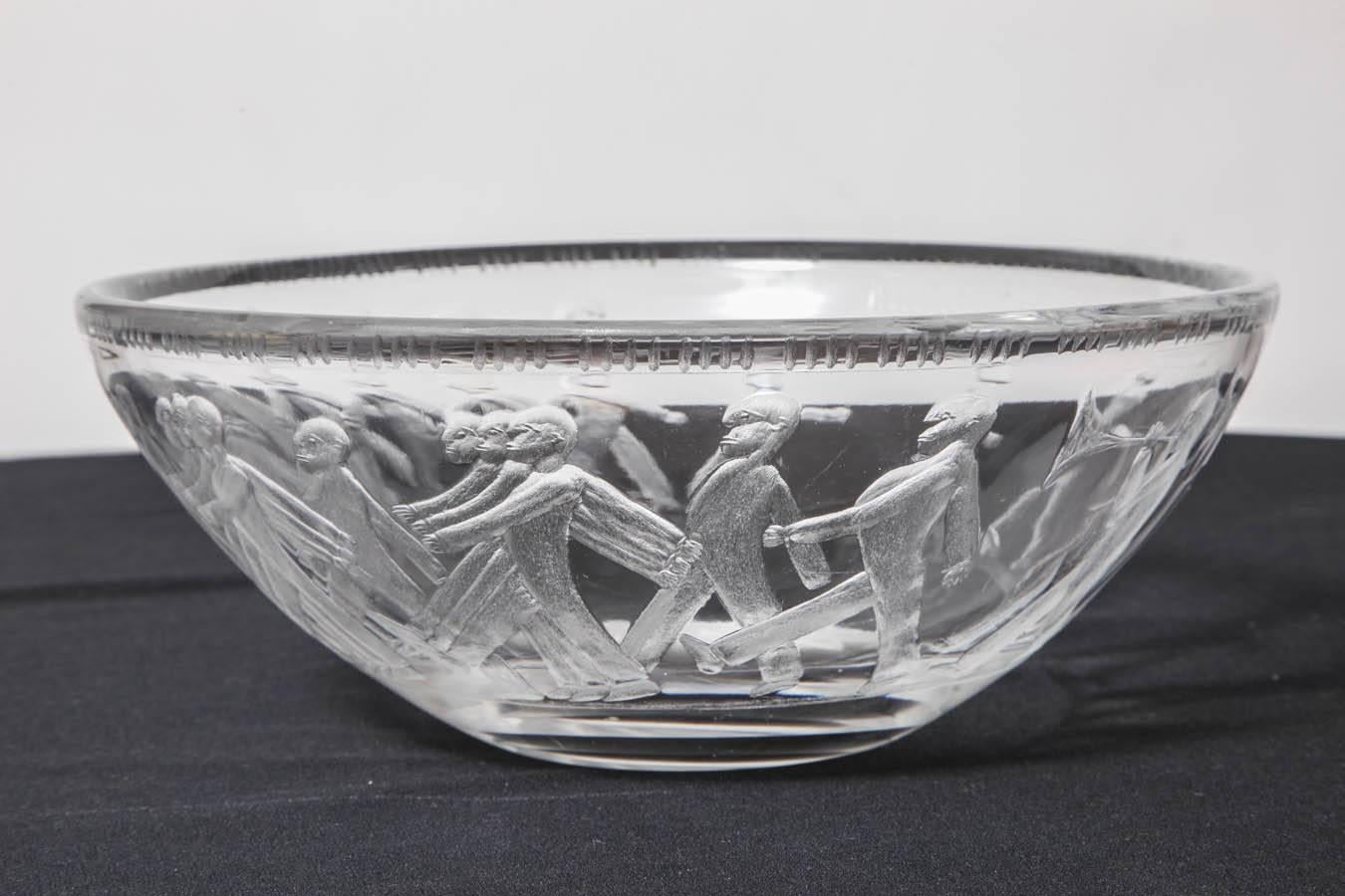 An Rare and Unusual Etched Glass Centerpiece Bowl by Erik Höglund for
 Kosta Boda, circa 1955. The Centerpiece is decorated all around with  
engraved marching men at some points etched three across.
Engraved on underside: 838/1185, Höglund