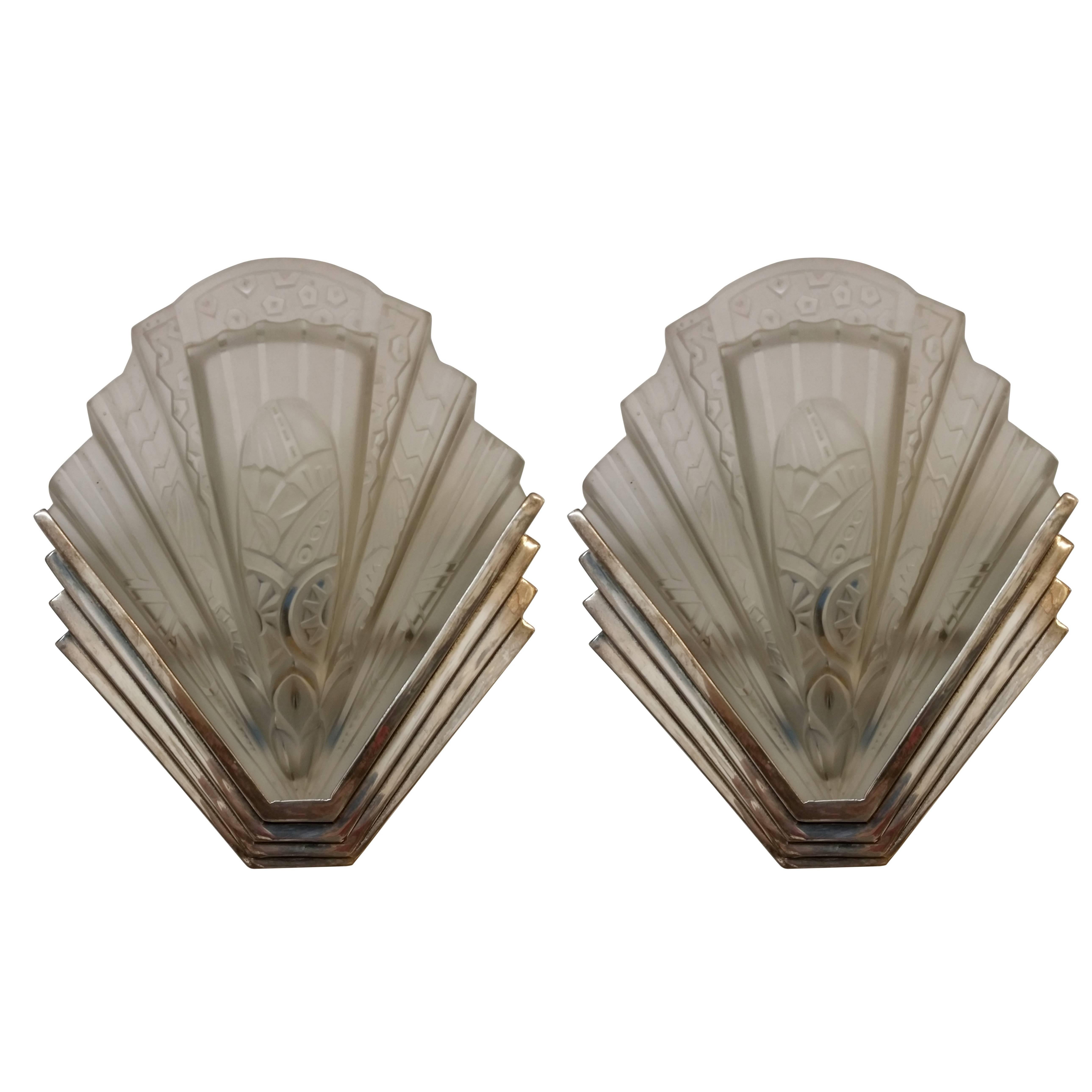 A pair of French Art Deco wall sconces signed 