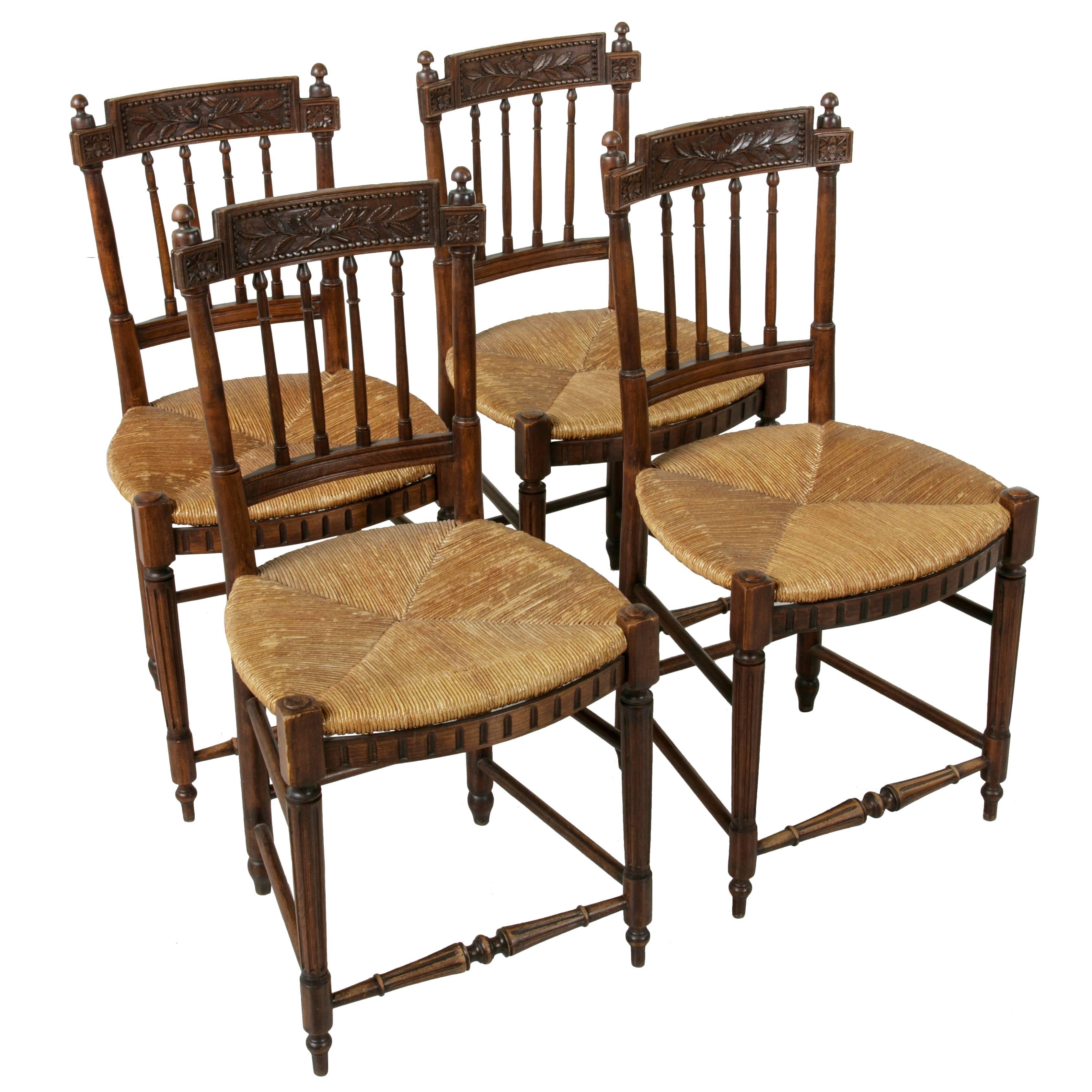 Set of Four 19th Century French Directoire Style Carved Walnut Rush Seat Chairs
