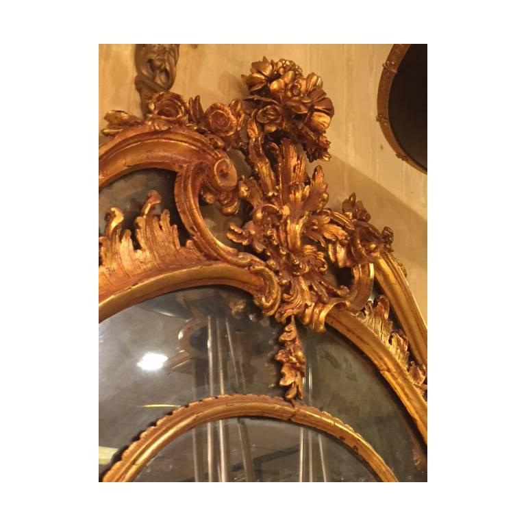 Large palace size Louis XV style giltwood pier mantel mirror with a domed, pierce carved floral crest.
Stock Number: M19.