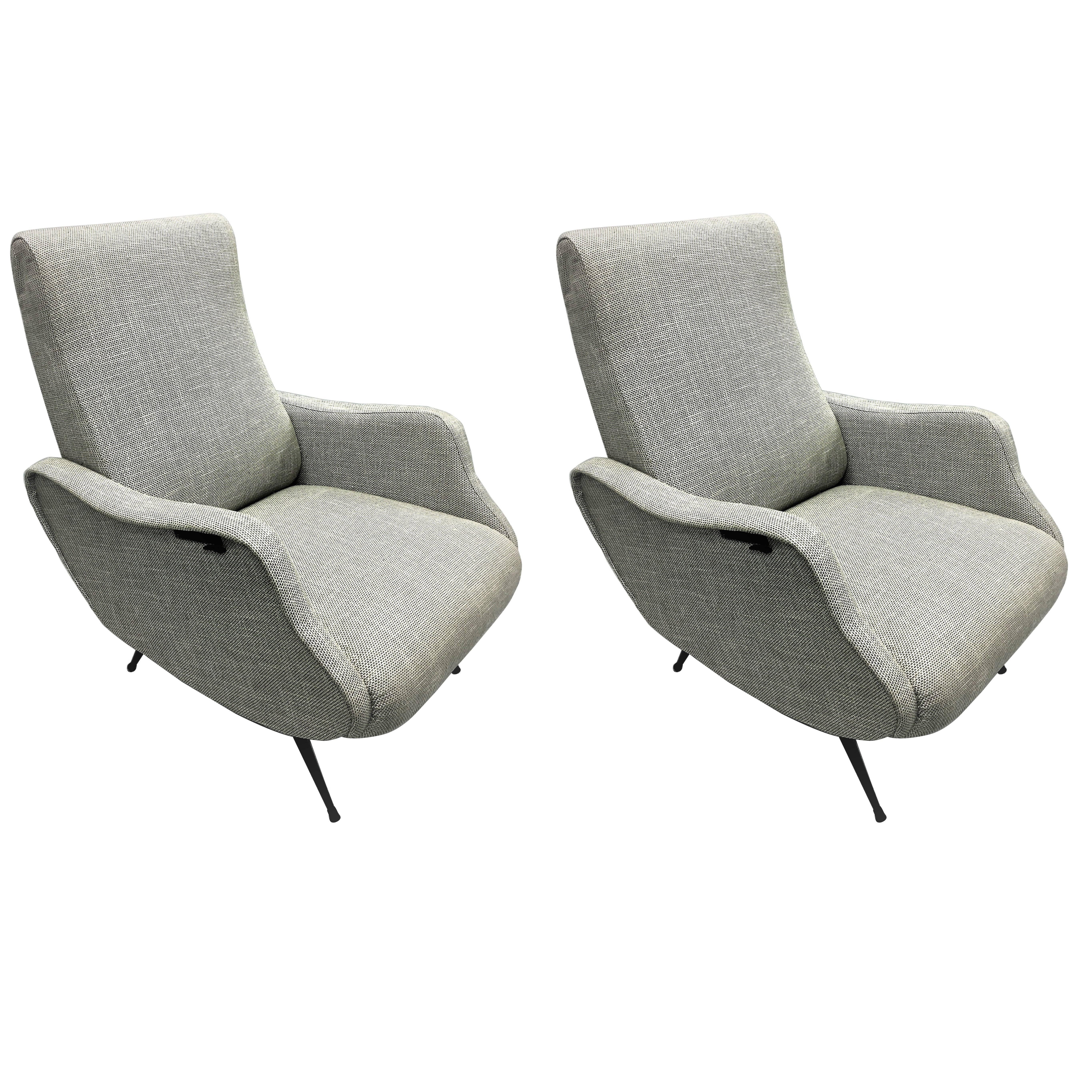 Elegant pair of Italian Mid-Century Modern reclining armchairs in the style of Marco Zanuso's Lady chairs, 1950. The pieces have generous size, recline and are very comfortable; they feature exquisite lines and detailing and have black lacquered