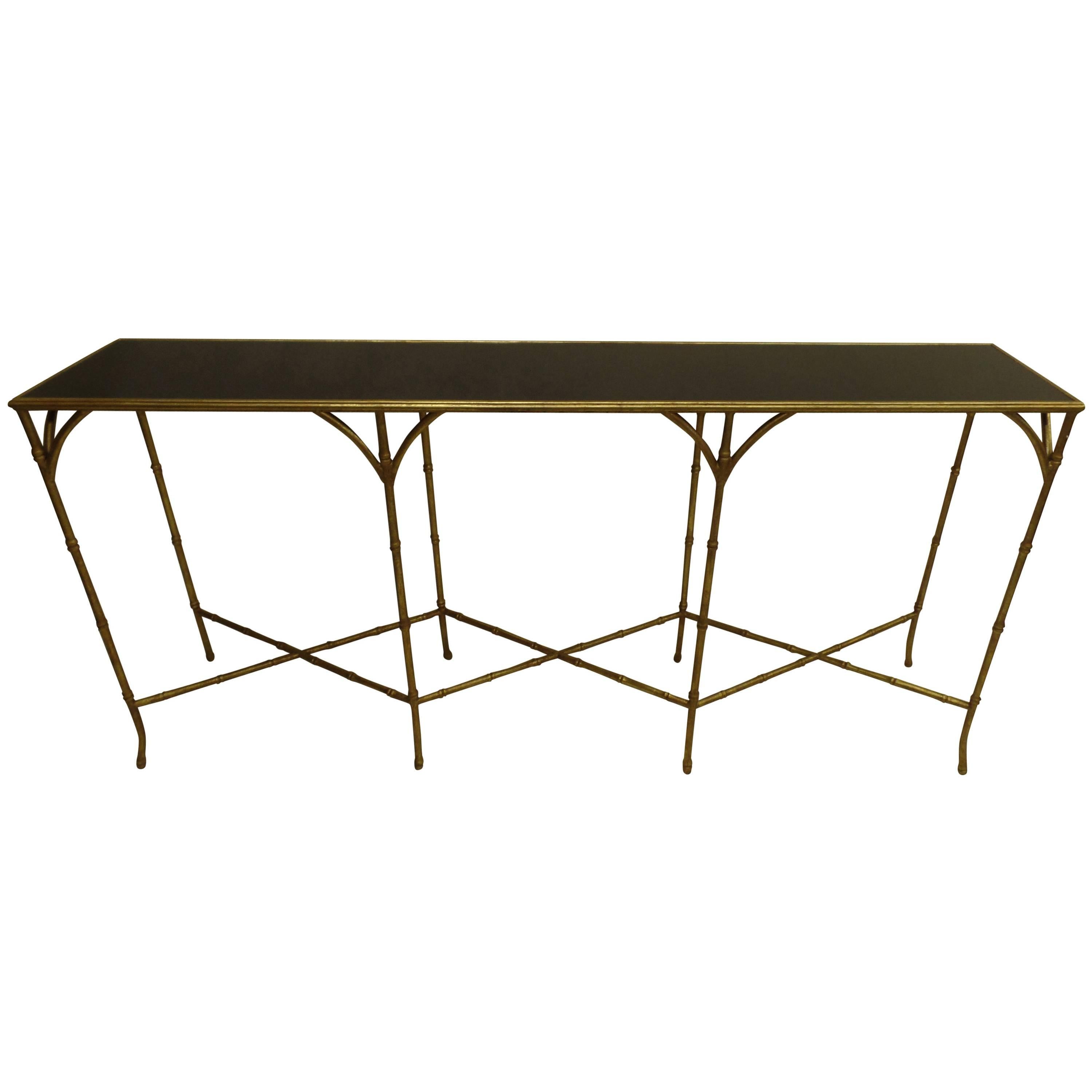 Large, Elegant French Mid-Century style console or sofa table in the modern neoclassical taste of Maison Bagues. 

The piece is elegantly composed of gilt iron faux bamboo with a unifyng double X frame stretcher and splayed feet. The top is inset