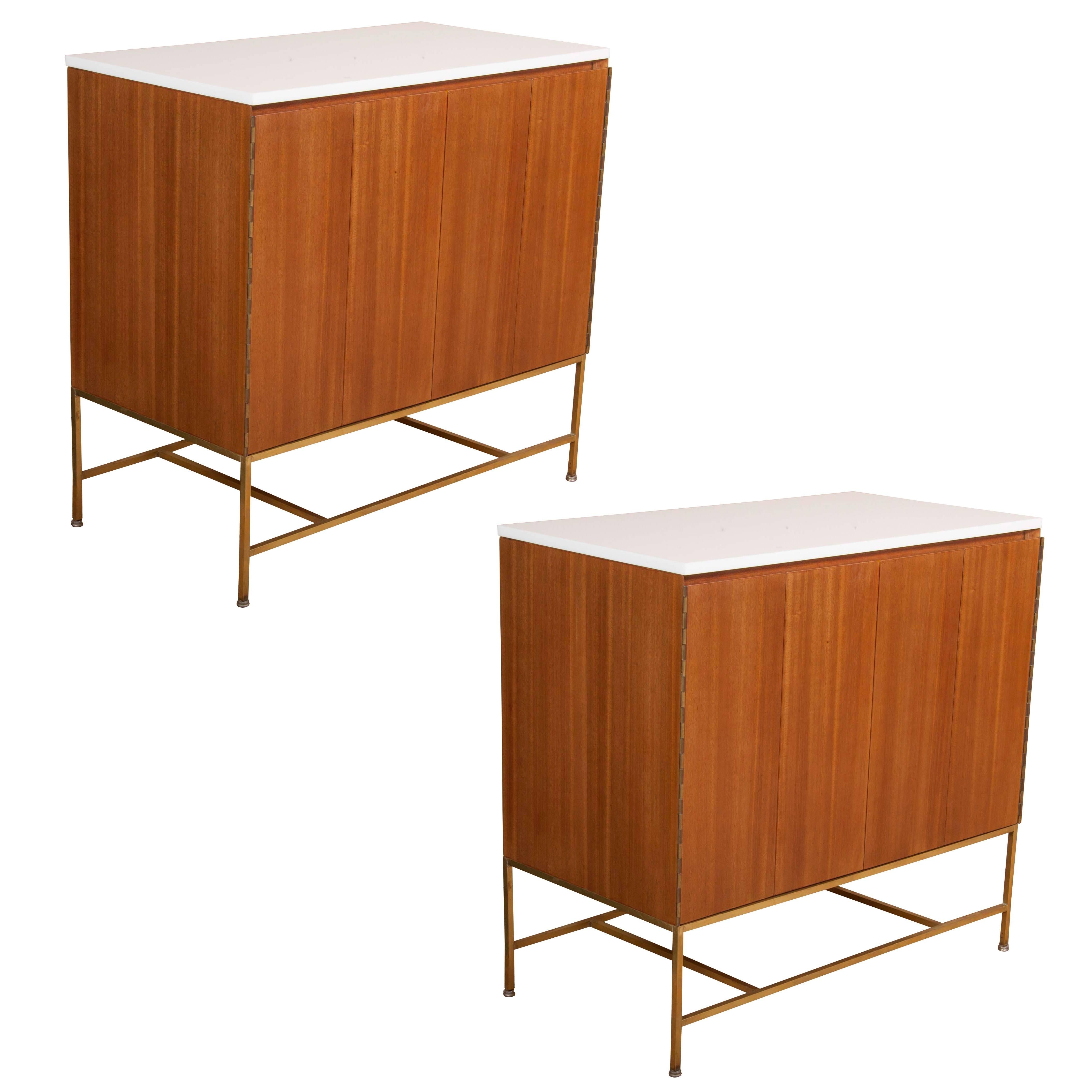 A Pair of Paul McCobb Cabinets with Vitrolite Glass Tops And Brass Stretchers