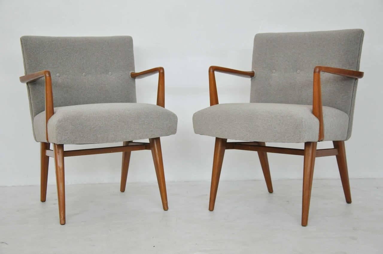 Set of four dining chairs designed by Jens Risom. Sculptural walnut frames in original finish with new upholstery.