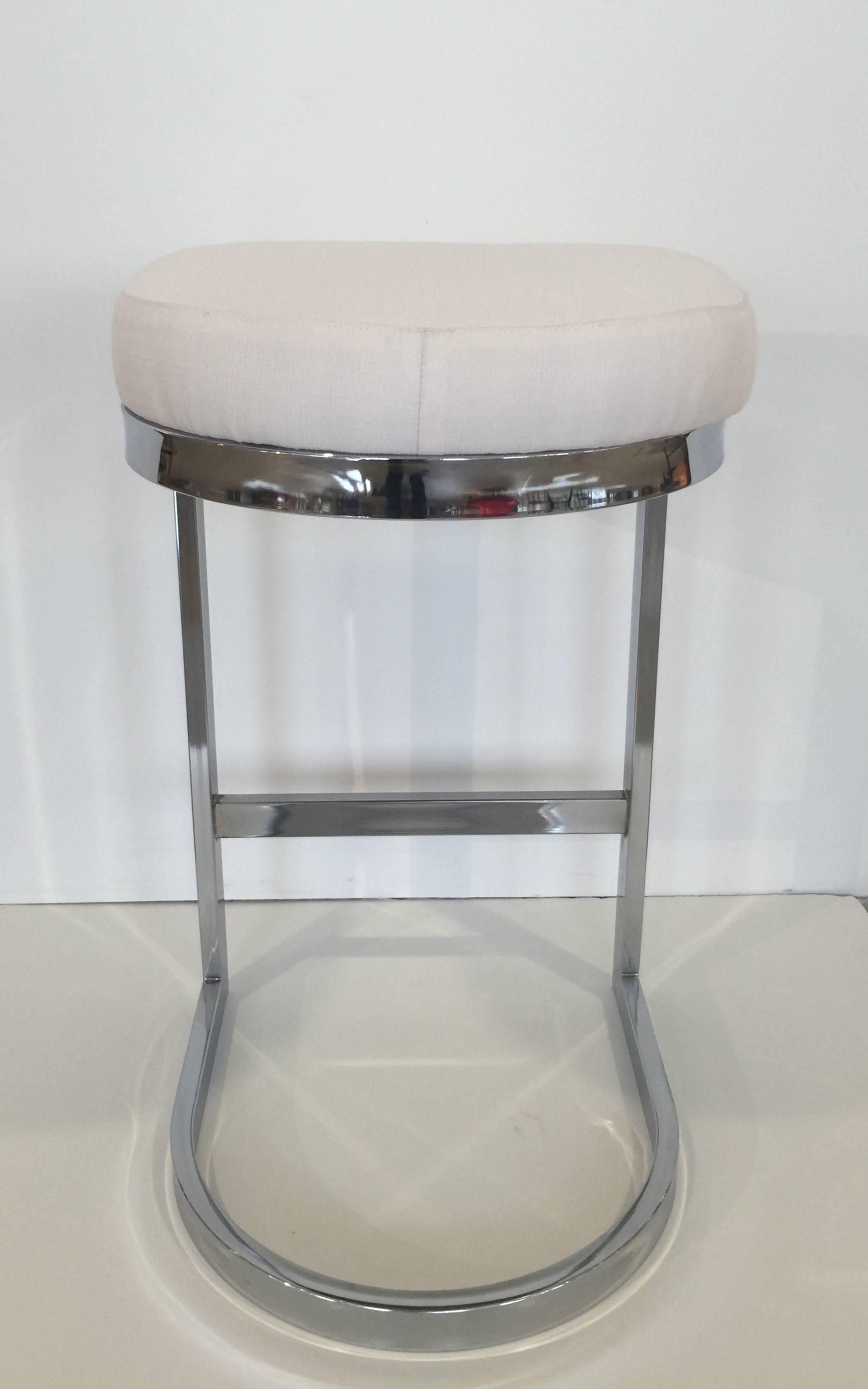 Chrome bar stool with upholstered seat by Design Institute of America. USA, circa 1970. Priced individually. Includes new re-upholstery in Sunbrella off white, linen-look fabric. Also available in COM/COL; one yard of fabric per stool and two week