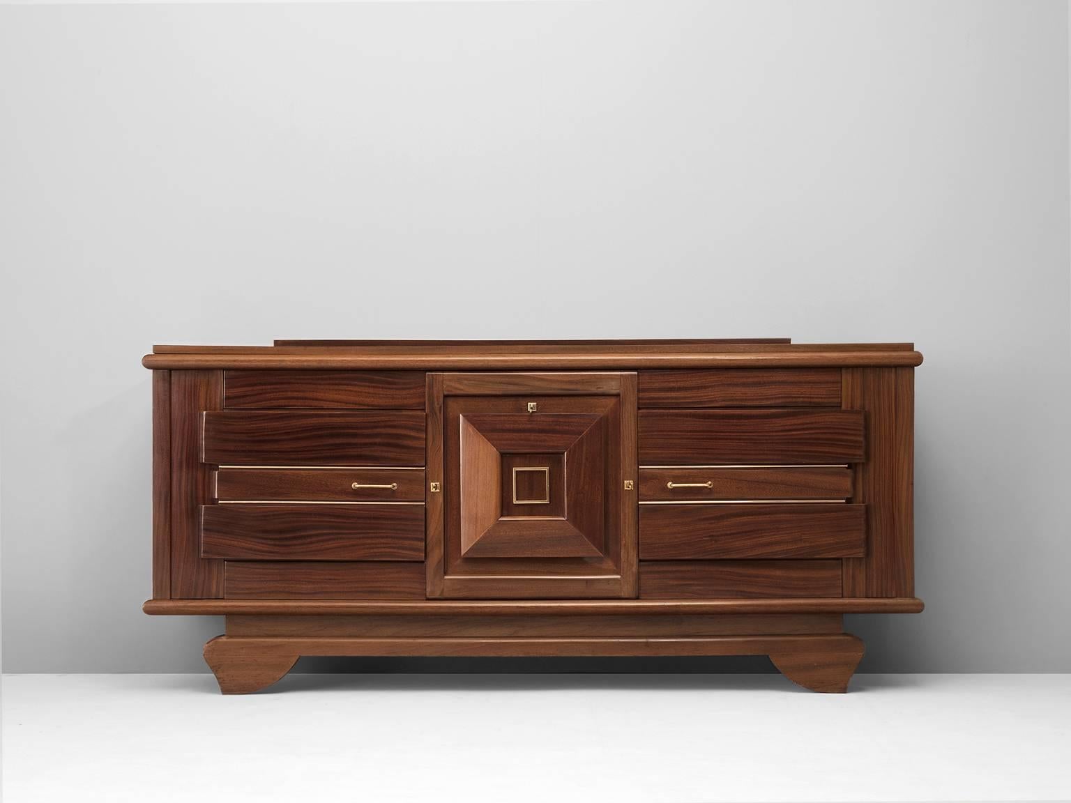 Credenza, in mahogany, France 1940s. 

Rare art Deco sideboards in solid mahogany and brass details. Well designed and crafted with beautiful details. Parquet top from mahogany veneer. Three doors, inside of shelves with decorated