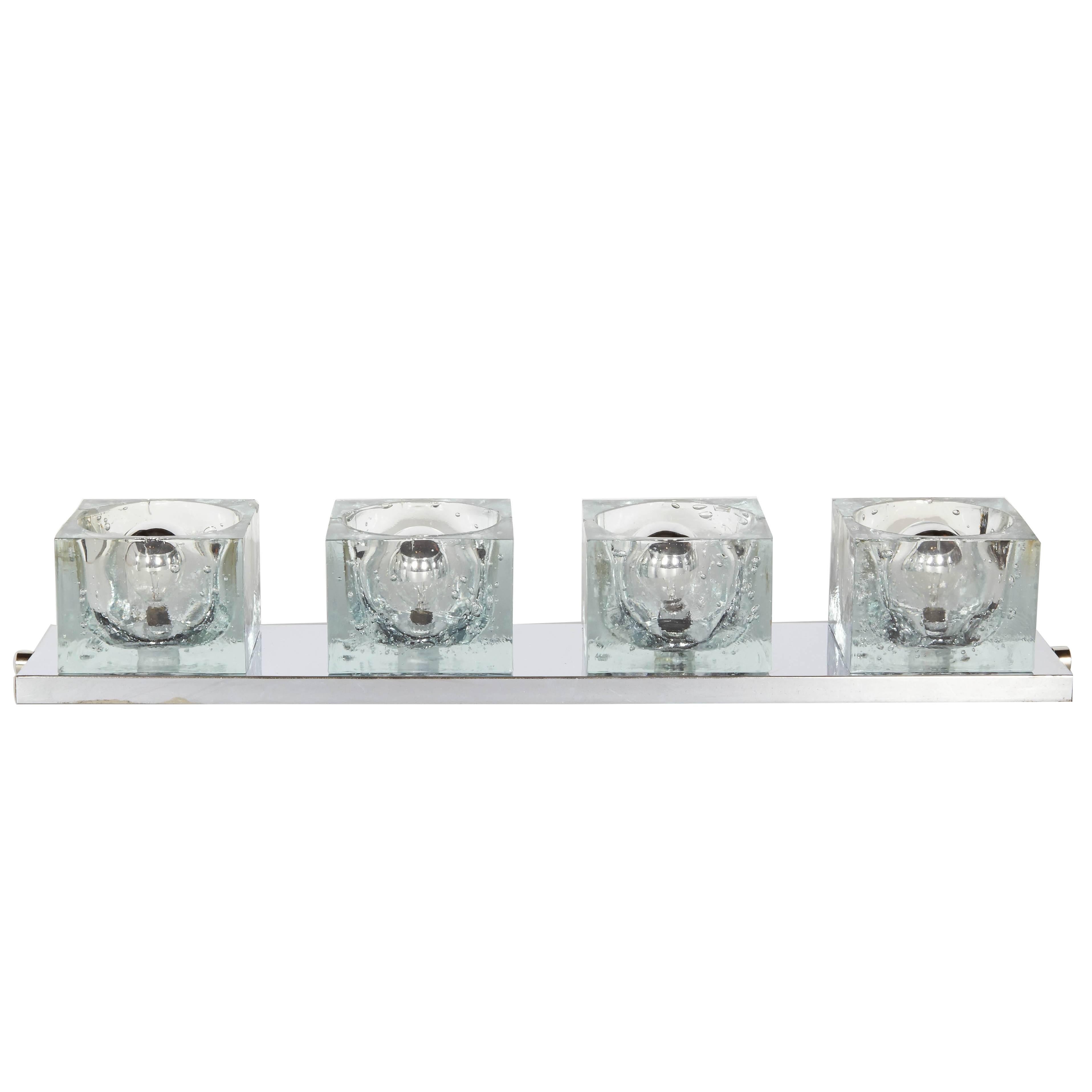 Cubist wall sconce featuring four large chunky glass block shades. Streamline polished chrome frame with cube glass design. Can be mounted vertically or horizontally. Shown with chrome tip bulbs.

Minor wear on frame and some glass components have