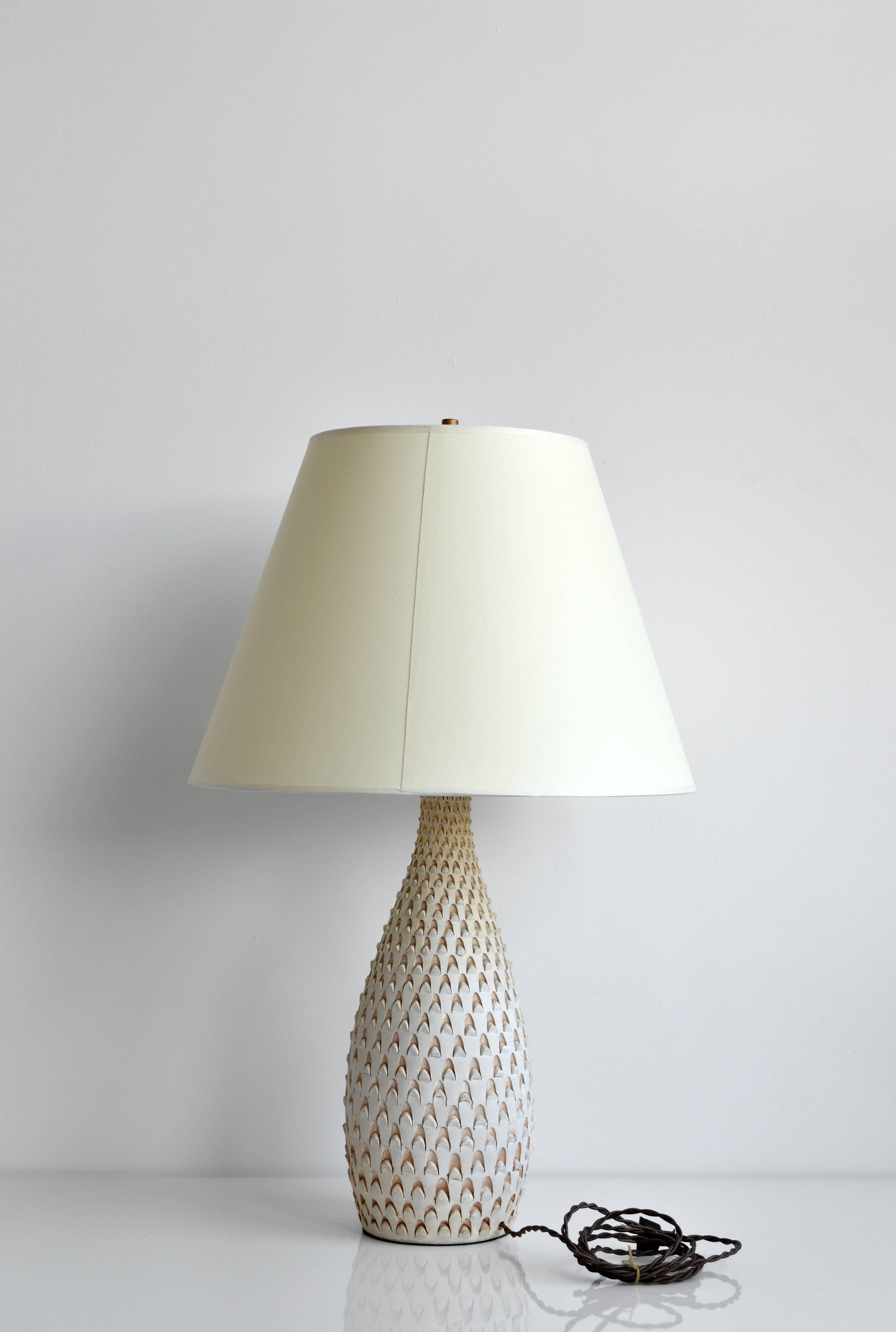Pottery lamp with textured detailing. Shade not included. Base diameter is 5.5