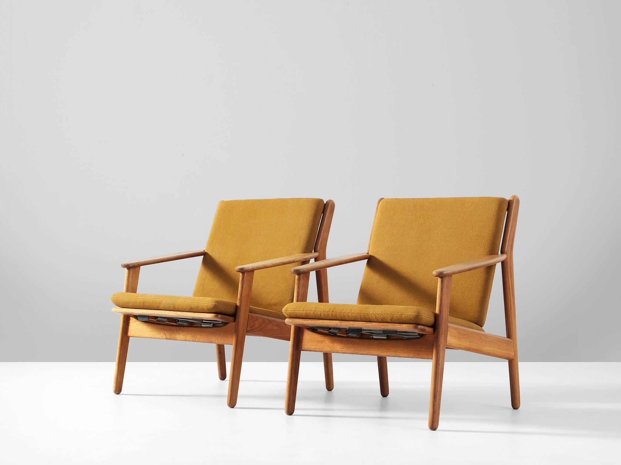 Pair of armchairs model J55, in oak and fabric, by Poul M. Volther for FDB Møbler, Denmark 1955.

Elegant pair of lounge chairs. The wooden frame of solid oak shows some interesting lines and details. The back nicely runs over into the hind-legs.