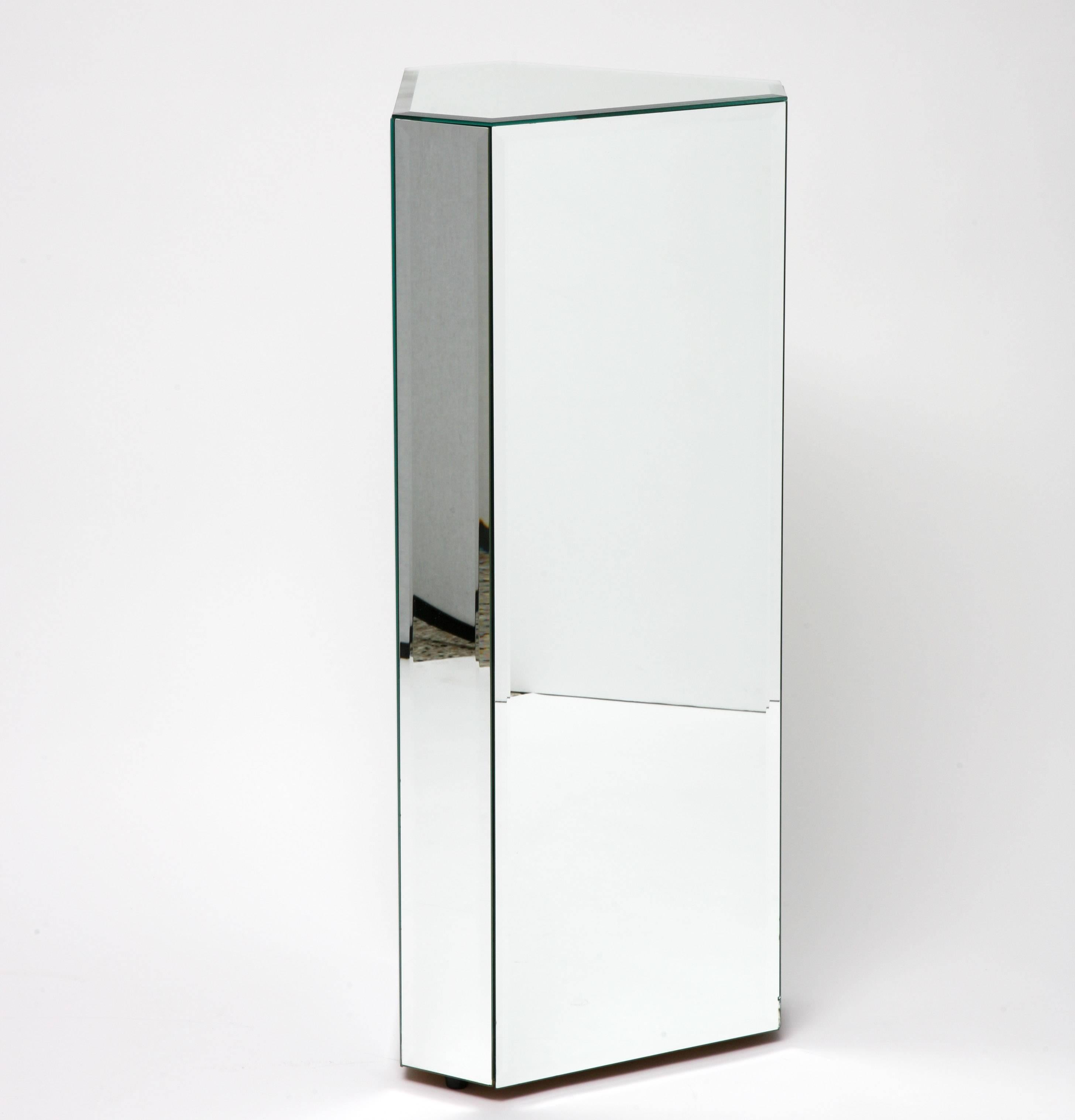 This pair of triangular shaped mirrored pedestals will make the perfect perch for your sculpture or perhaps potted orchids.

