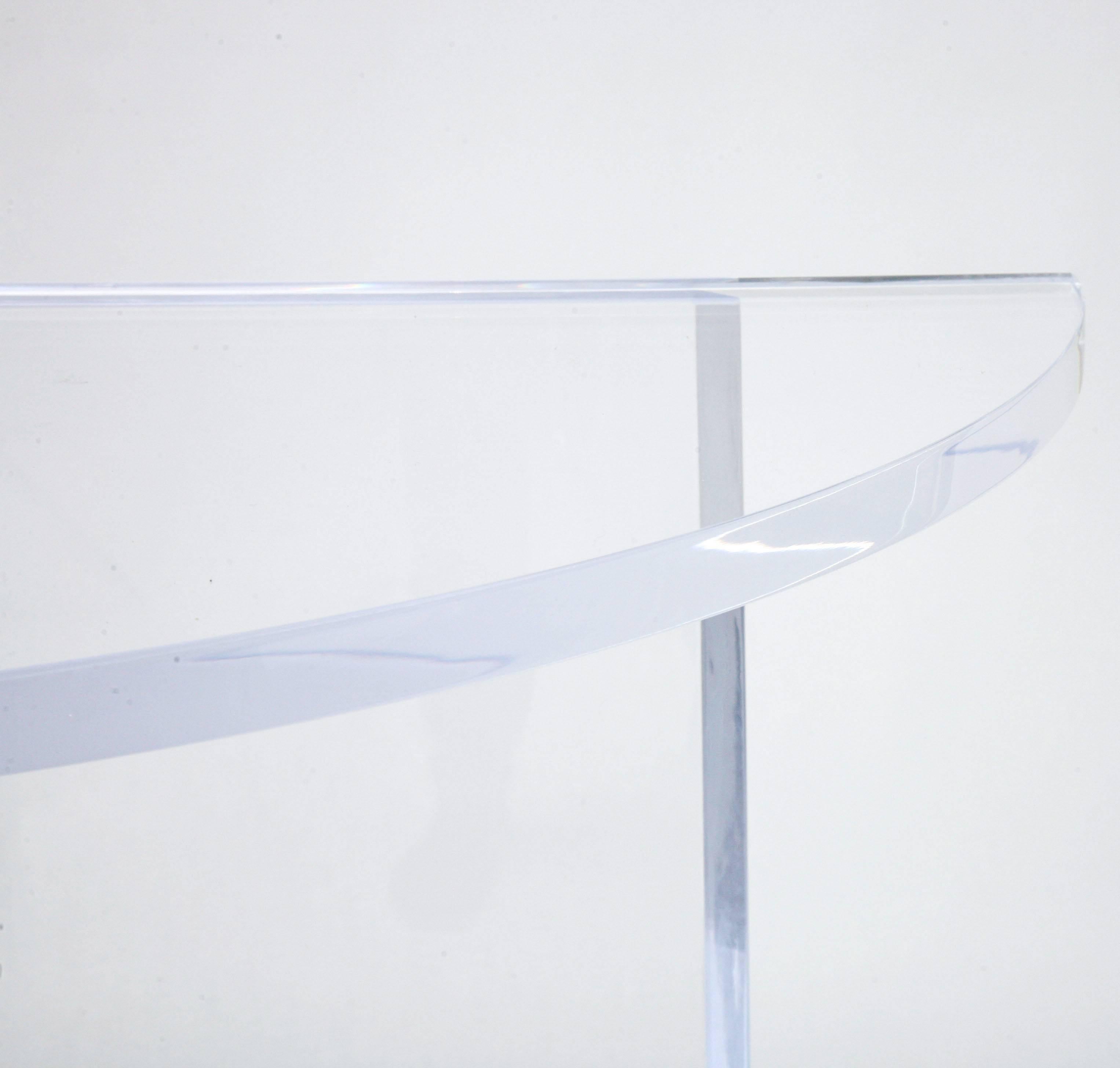 This bespoke Lucite demilune console took its clean-lined inspiration from pieces by the iconic designer Charles Hollis Jones in the 1970s. The piece has 1' thick Lucite top and base which gives it a substantial yet lite presence. 

Note: The top
