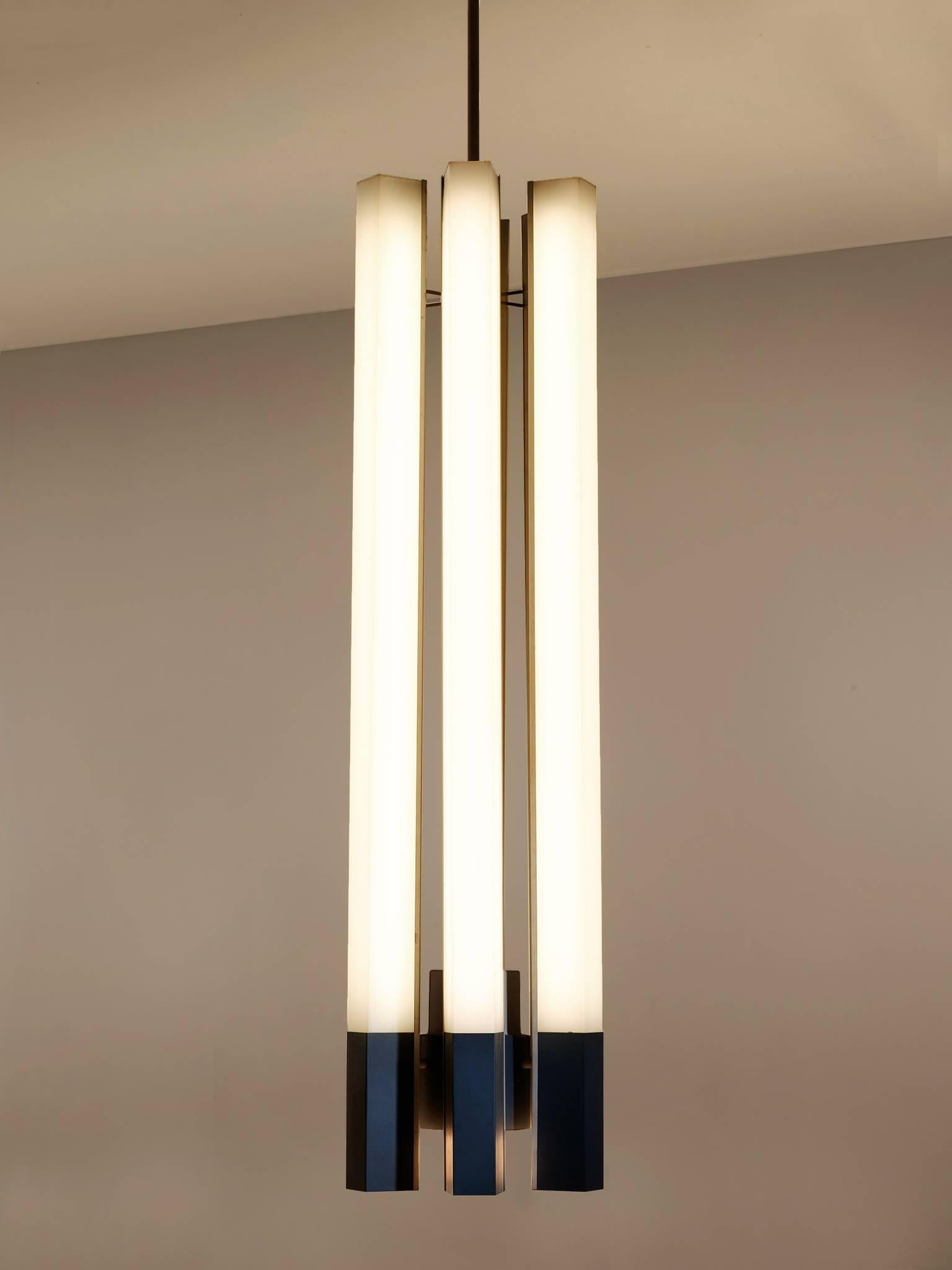 Chandelier, in metal and Lucite, Germany, 1970s. 

Very large fluorescent tube chandeliers. These lights have an interesting appearance each pendant consist of six fluorescent tube lights with a Lucite shade, captured in a metal frame. The lights