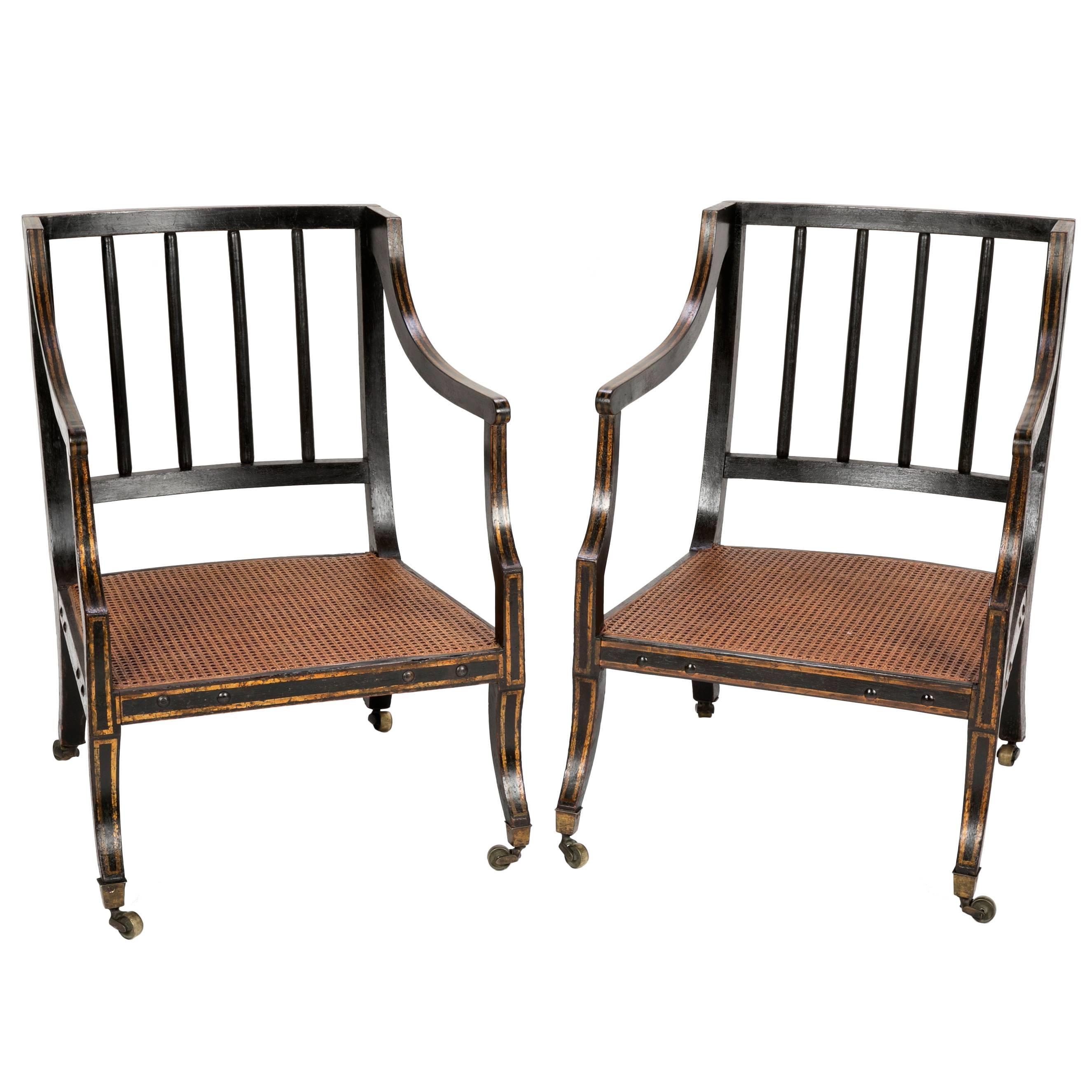 Pair of Regency Ebonized and Gilded Caned Armchairs