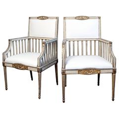 An 18th century Pair of Italian Painted and Parcel-Gilt Armchairs