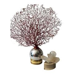 A Coral in a 1970's metal base with rock crystal piece in steel base