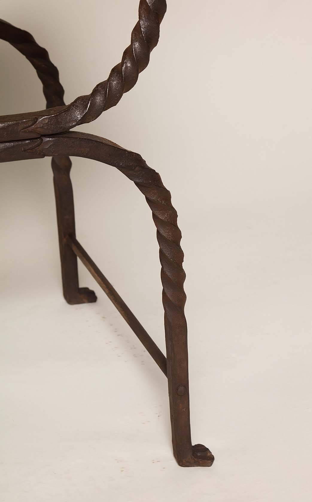 Rare set of four Italian Baroque iron folding benches (Faldistorio) with pomegranate bronze finials and turned bronze shafts, the 