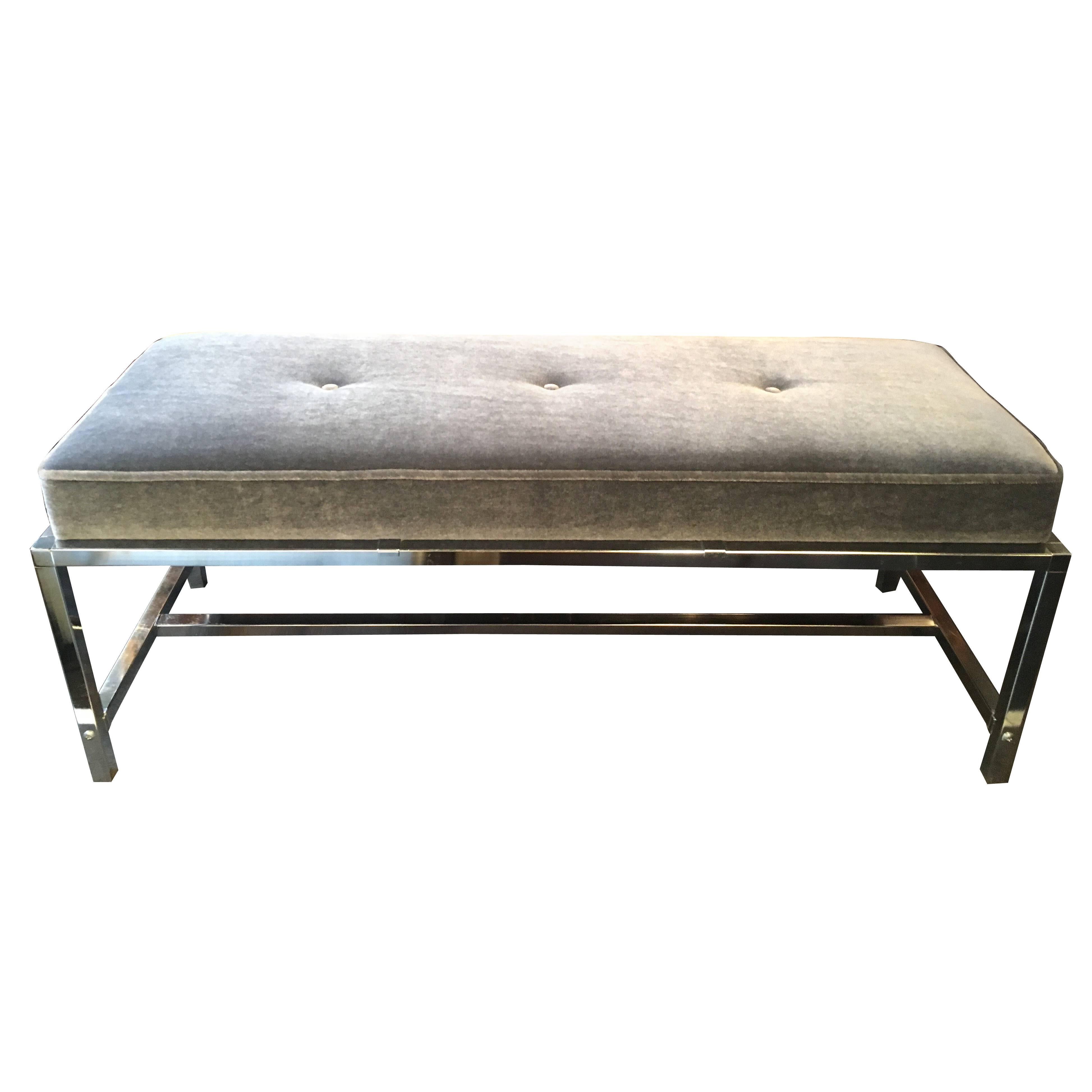Mid-century modern bench newly upholstered in luxurious grey mohair.  Streamline design and features polished chrome over steel base with center crossbars. Has three button accents and self welt edges. 