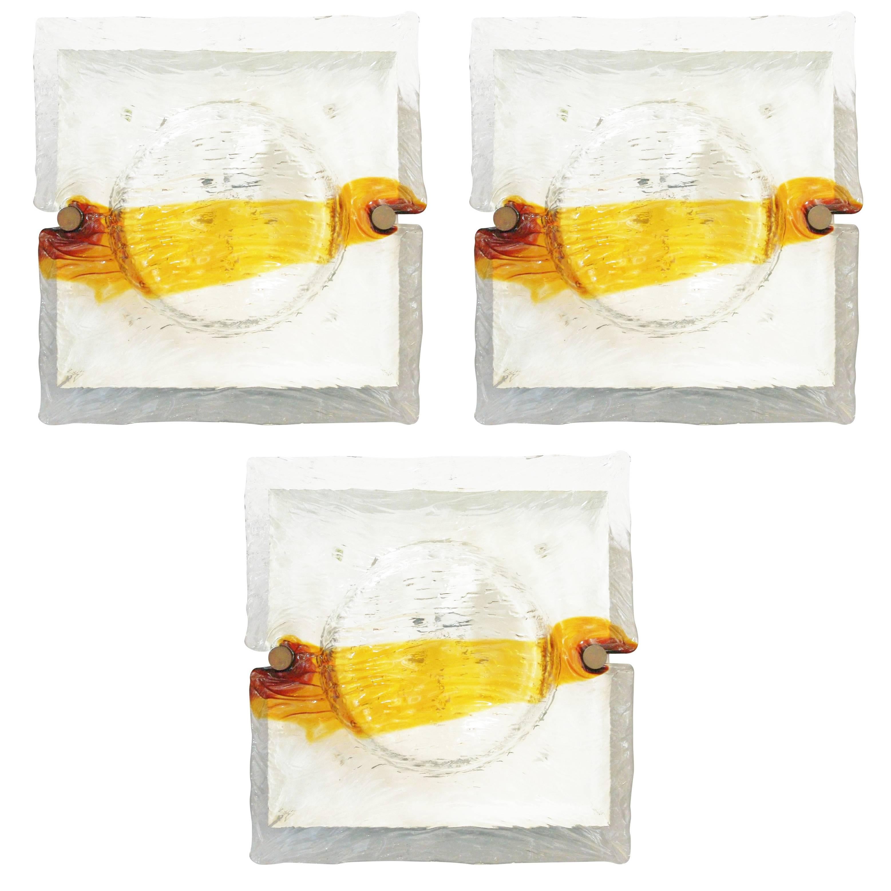 Vintage Italian wall lights or flush mounts with amber and clear Murano glass hand blown in to a quilt-like effect / Designed by Venini, circa 1960’s / “Venini Murano” mark on the frame / Made in Italy 
1 light / E26 or E27 type /max 60W 
Heigth: 17