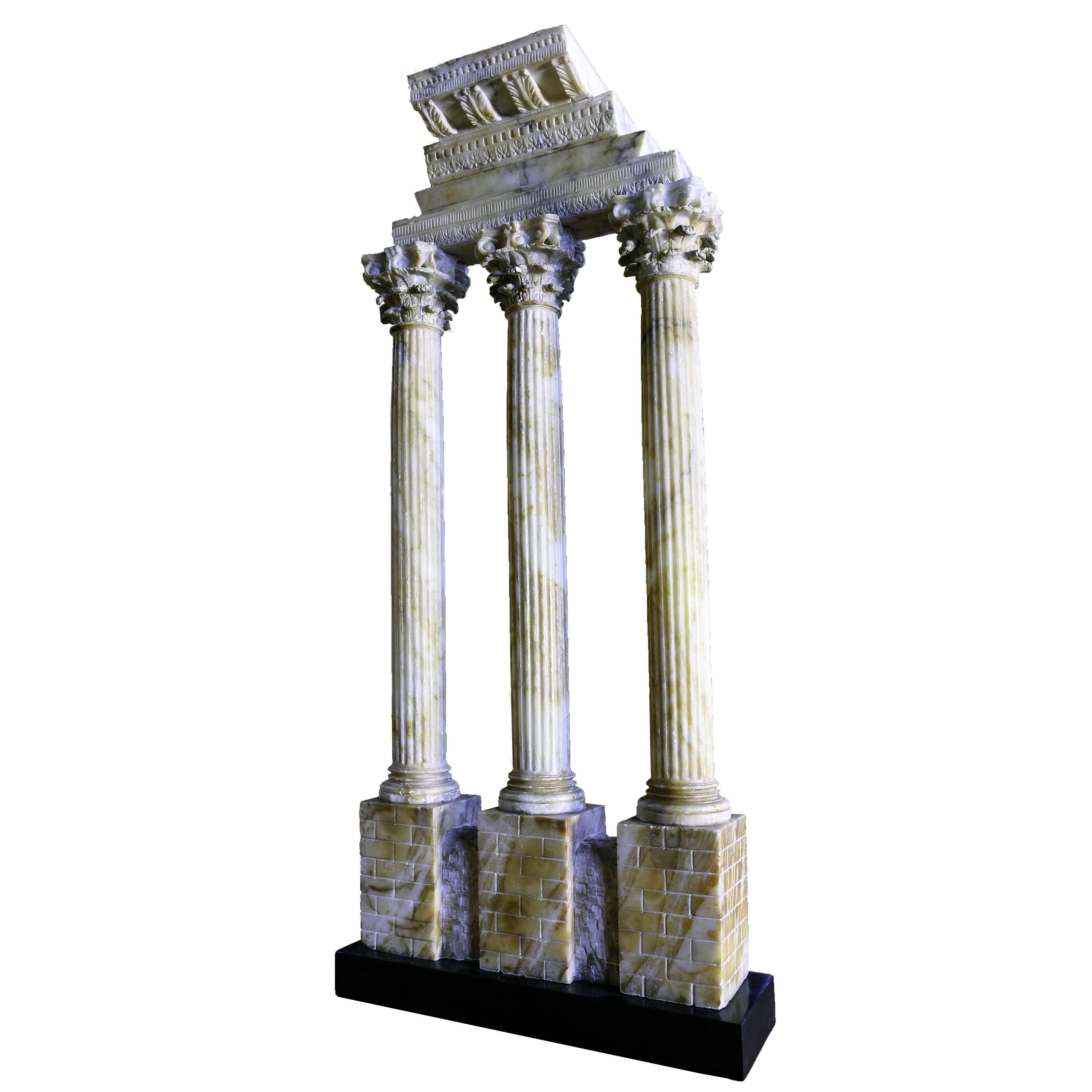 While we are familiar with similarly sized, carefully-carved, circa 1870 replicas of this monument in antique yellow marble (giallo antico,) the present souvenir is more unusual. Realized in a veined, yellow, Italian alabaster, this 27-3/4” high