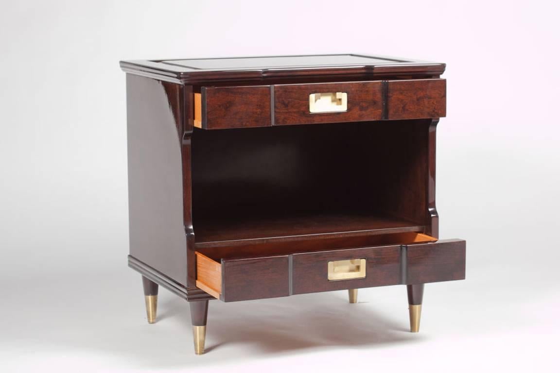 Pair of mint restored Mid-Century nightstands with classic styling. Nightstands are refinished in a dark Walnut stain, with satin brass pulls and sabots.