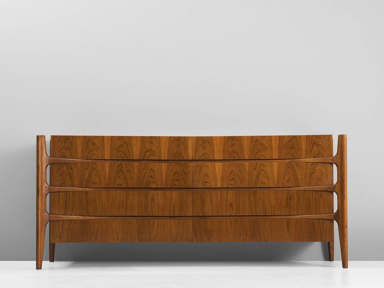 Sideboard, in walnut by and documented: William Hinn for Urban Furniture Company, Sweden, 1950s.

Beautiful curved double dresser. This credenza shows an exquisite organic and amorph design. The wooden frame reminds of a skeleton, the large set of