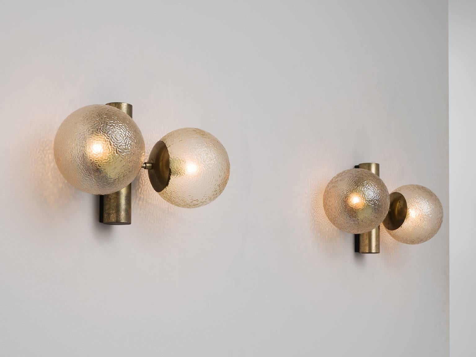 Set of four wall lights, in metal and structured glass, Europe, 1970s.

Set of four wall lights. These lights have a simplistic design. It's strength is in the combination of the forms and materials. The fixture is a large tube, two large globe