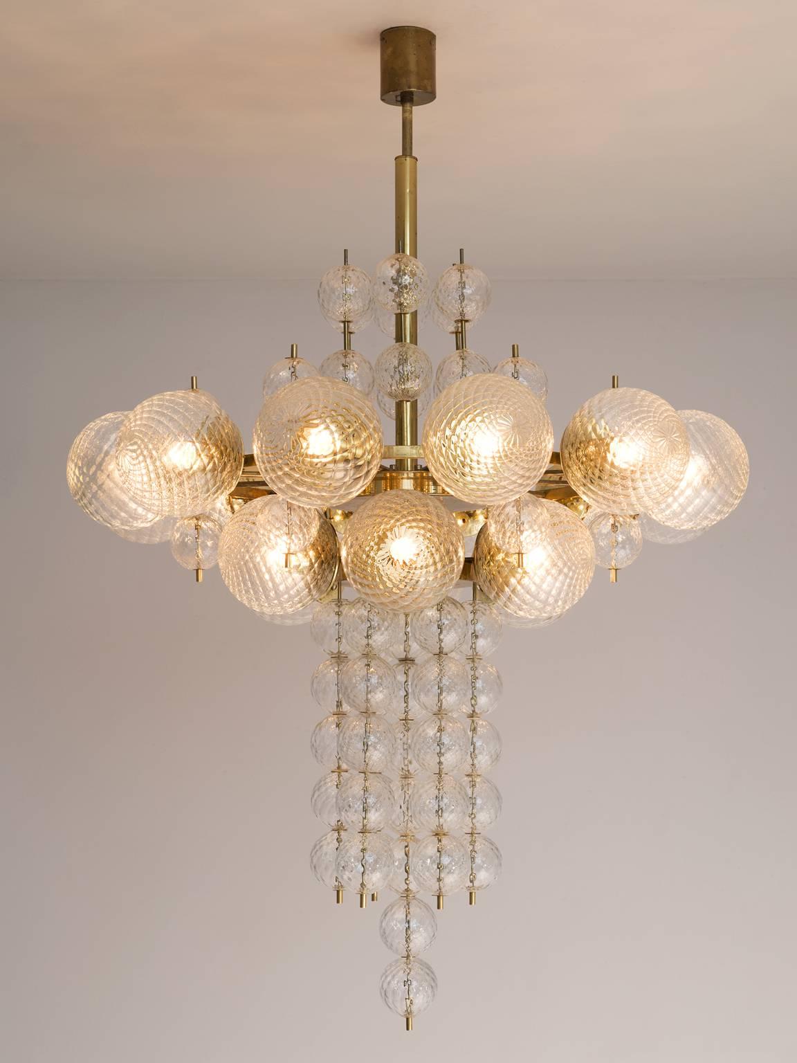 Chandelier in glass and brass, Europe 1970s.

Large chandelier in structured glass and brass. The structured glass brings a stunning light partition. The patinated brass creates a warm atmosphere. Four items available.

Price listed per item