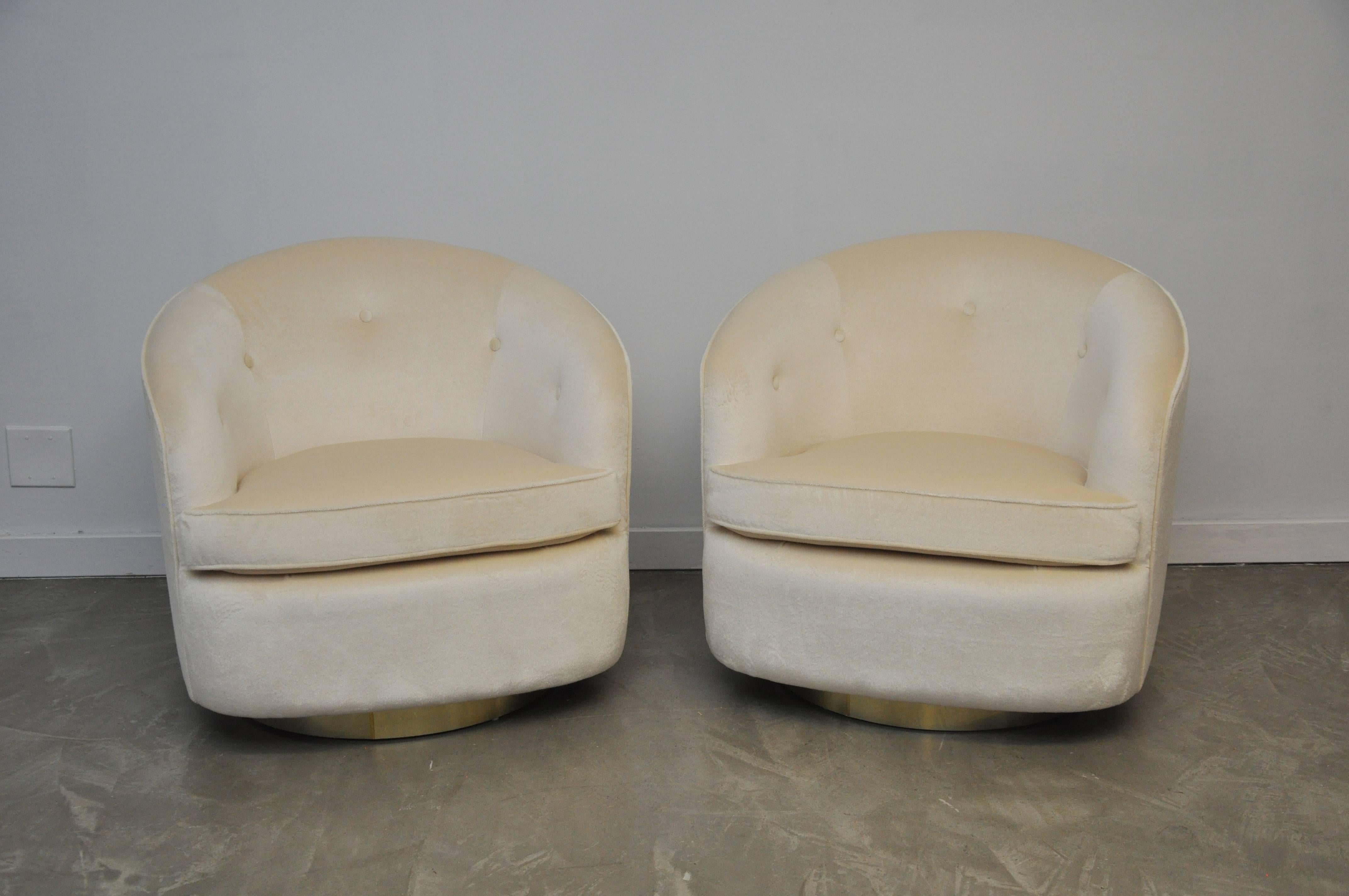 Set of four brass base swivel chairs by Milo Baughman. Fully restored and reupholstered in cream mohair.

Also available in pairs.