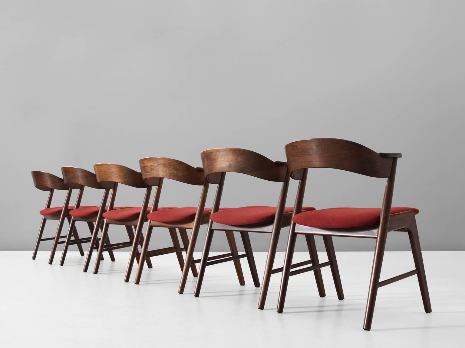 Set of six dining chairs in rosewood, teak and fabric by Kai Kristiansen for KS Møbler, Denmark, 1950s.

The chairs show beautiful and well designed lines and joints. The curved back and armrests are mounted on the oblique rear legs, which provides