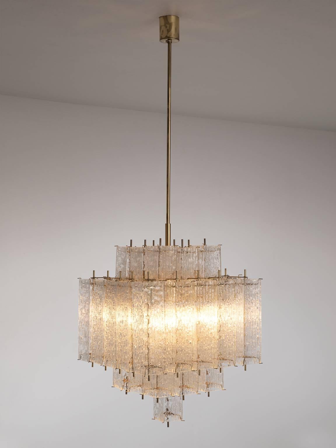 Chandelier, in glass and brass, Europe, 1970s. 

Large square chandelier with a great amount of glass shades. The frame is made of brass and holds numerous structured glass 'tubes' with a brass center. Due the combination of materials and all the