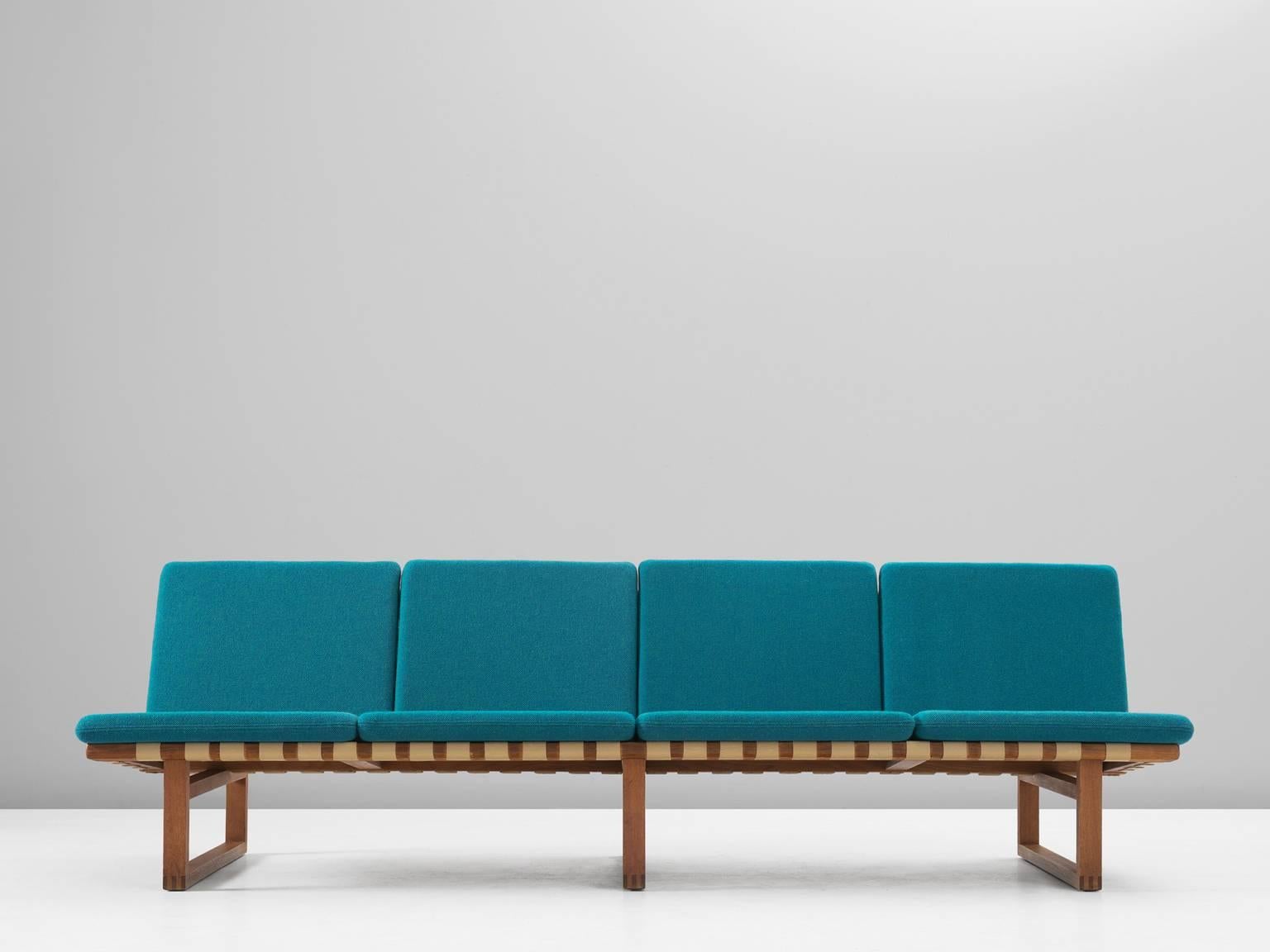 Sofa model 211, in oak, fabric and webbing, by Børge Mogensen for Fredericia Stolefabrik, Denmark, 1956. 

Four-seat bench in oak. Simplified design by Danish designer Børge Mogensen. An early design of Mogensen and precursor for his famous wooden