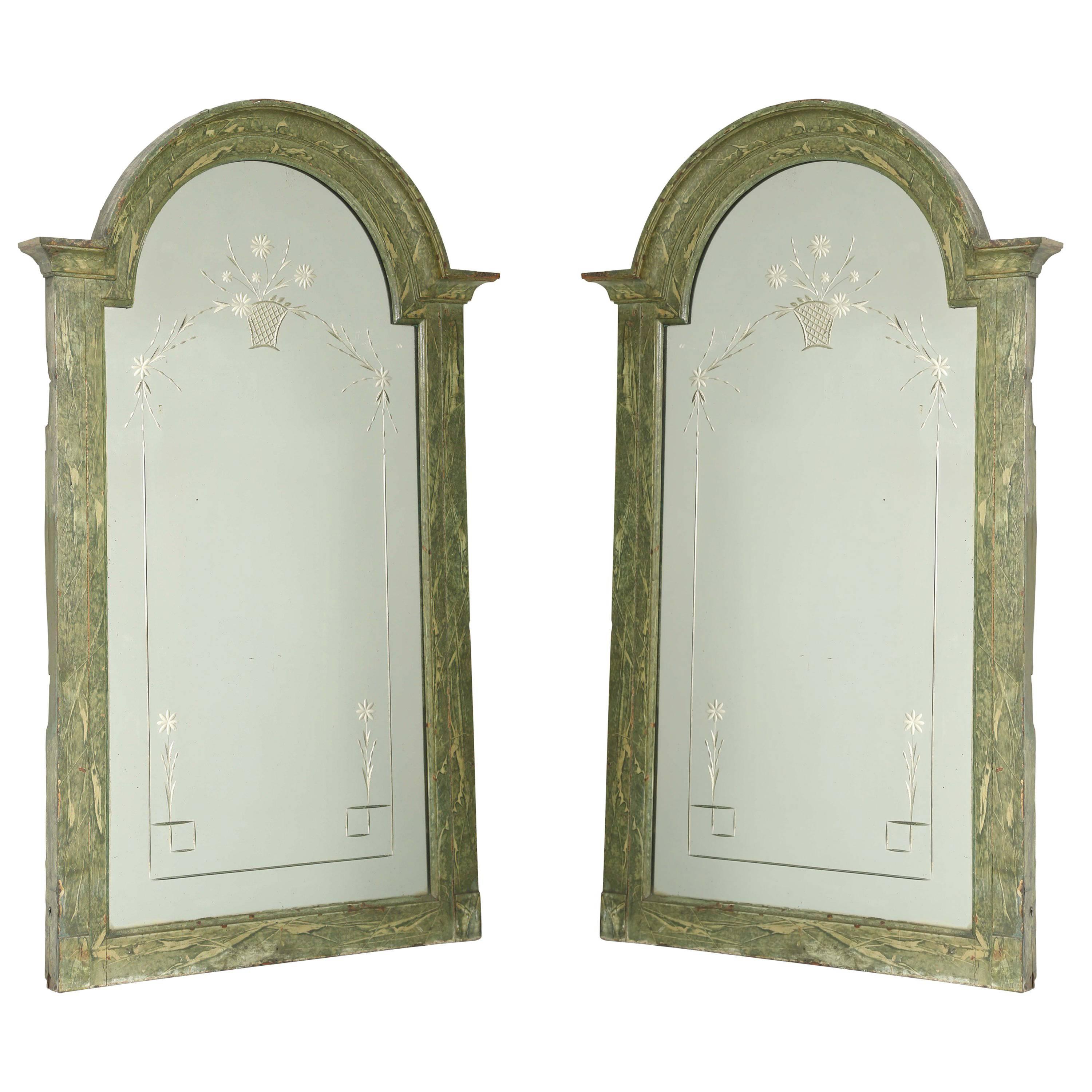 Pair of mirrors, each holding a rectangular mirrorplate with arched top, both etched with flower basket and Meander border, in carved, conforming, frame, with painted finish showing natural wear.

Stock ID D9382