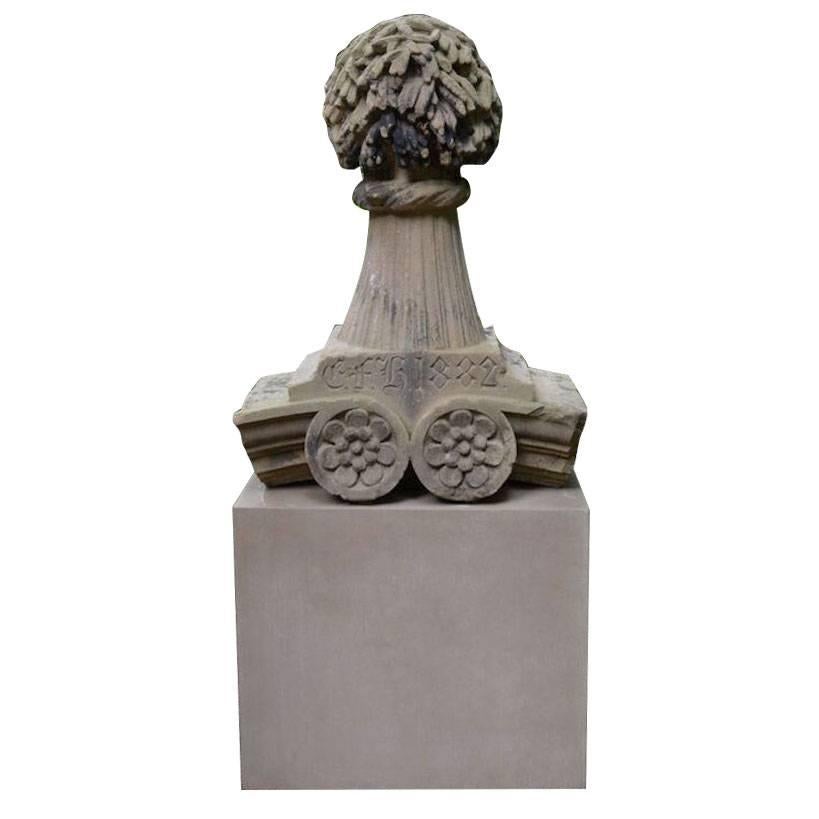 A carved stone finial in the form of a sheaf of wheat, English, inscribed “EFH” and dated 1882. It has a large rectangular base that isn't shown in the pictures. 
45 ins. high, 33.5 ins. wide, 18 ins. deep. 
Provenance: By repute, from the Corn