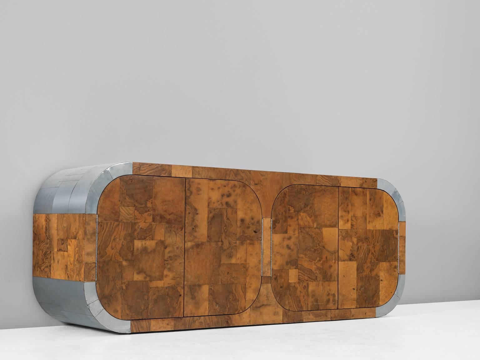 Sideboard from the 500 series, in burl wood and metal, by Paul Evans, United States 1970-1975. 

Magnificent curved sideboard by American designer Paul Evans. This cabinet shows a patchwork motive of burl wood and metal. Evans is known for his use