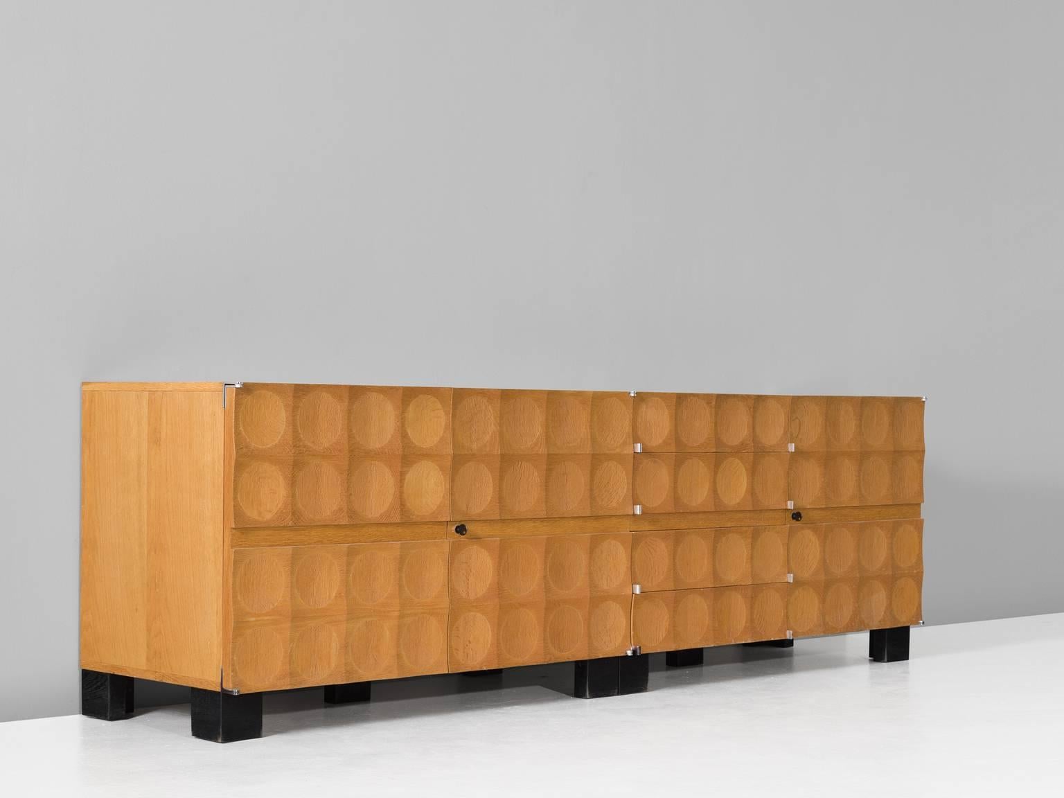 Sideboard, in oak, by De Coene, Belgium, 1960s. 

Rare natural sideboard in oak by De Coene freres. This Brutalist credenza shows a beautiful graphical front. Each door is ribbed and decorated with circles. Therefore a dimensional expression is