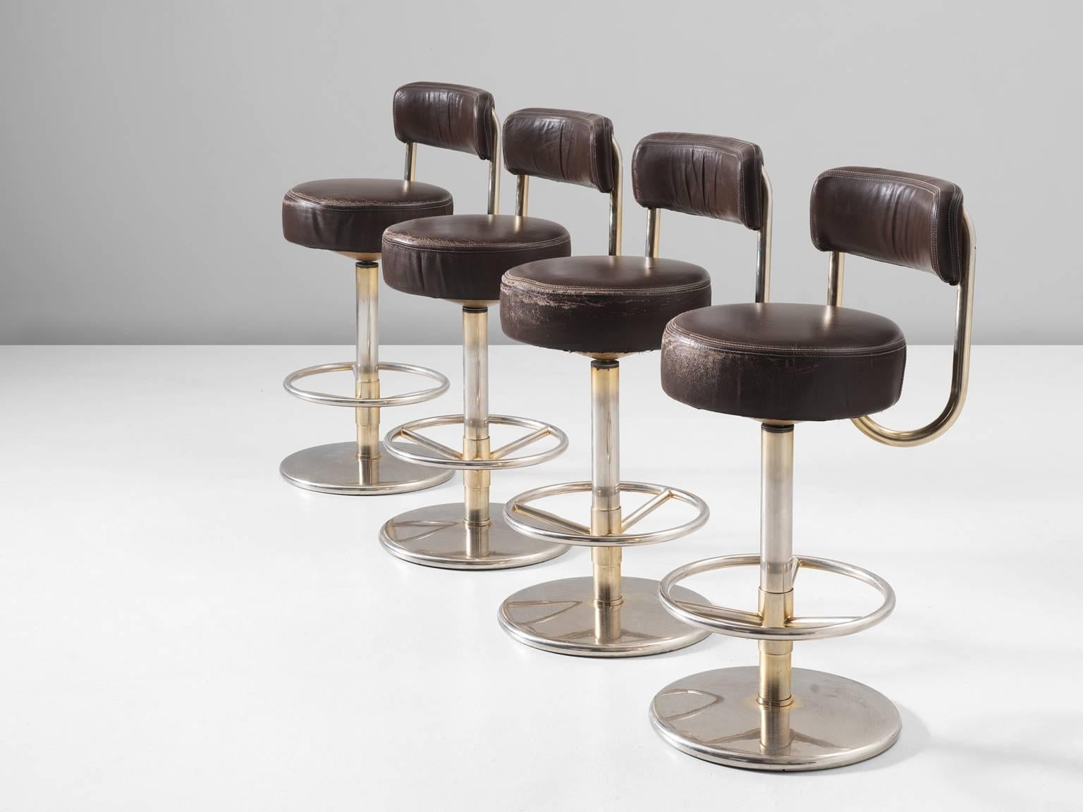 Set of four bar stools, in metal and leather, Scandinavia, 1970s. 

Set of four modern chrome swivel barstools in Hollywood regency style. These comfortable high barstools are in original brown leather upholstery. Due to the soft seat and back,