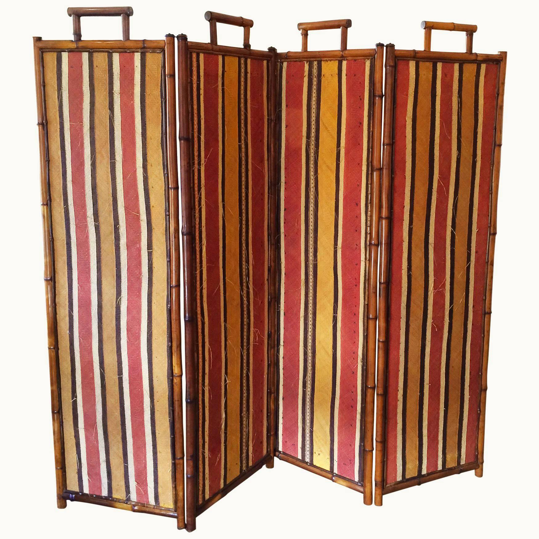 A very unusual four panel screen by Perret et Vibert; with woven hand painted striped straw panels on each side; framed in natural bamboo with designer's label, circa 1890.
Each panel is 19.75" W.