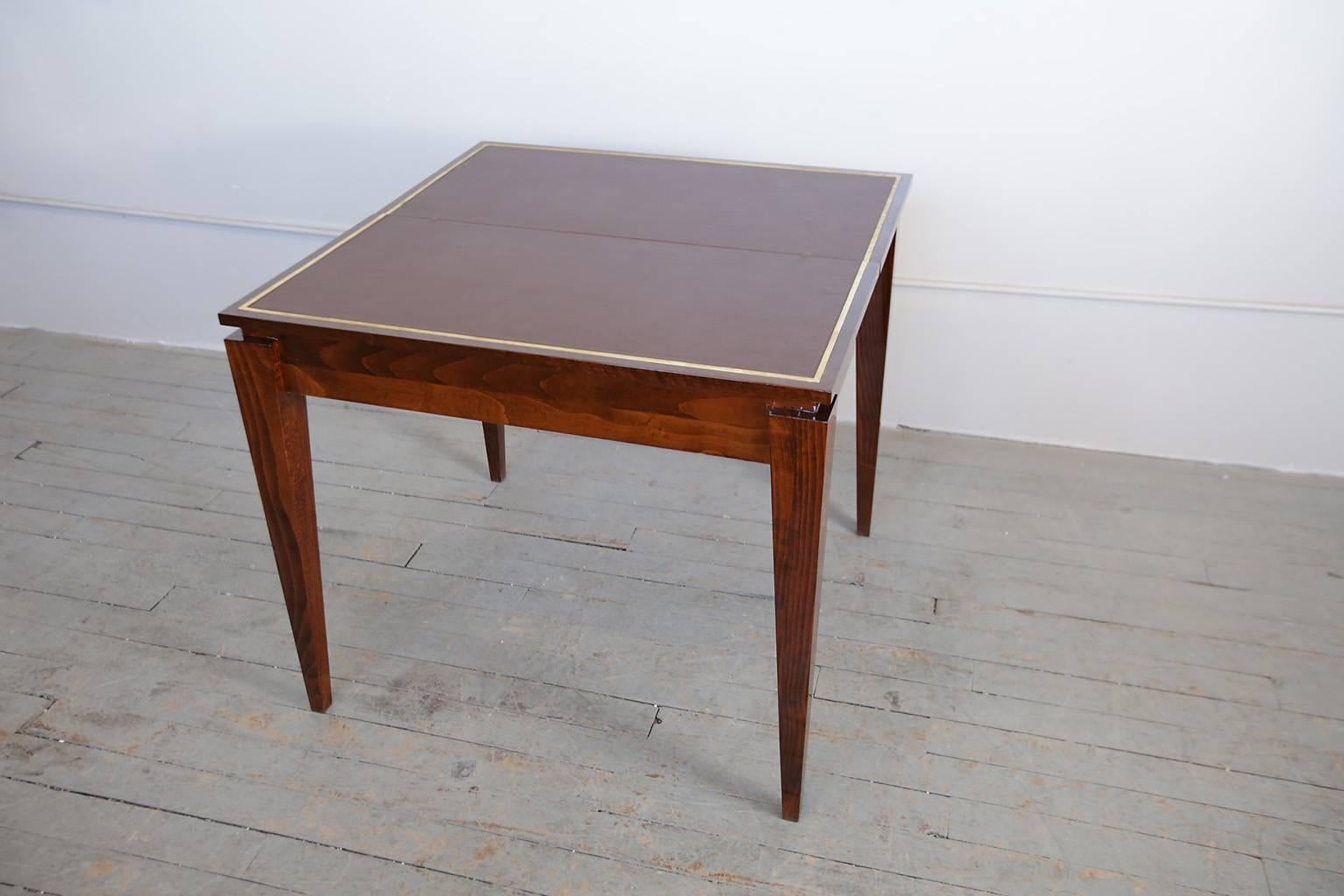 Console table opens up to a card table. 
When open this card table measures 34' x 34" x 29.75"
When closed this table can serve as a console table measuring 34" x 17" x 30.5".
Walnut wood with leather top.