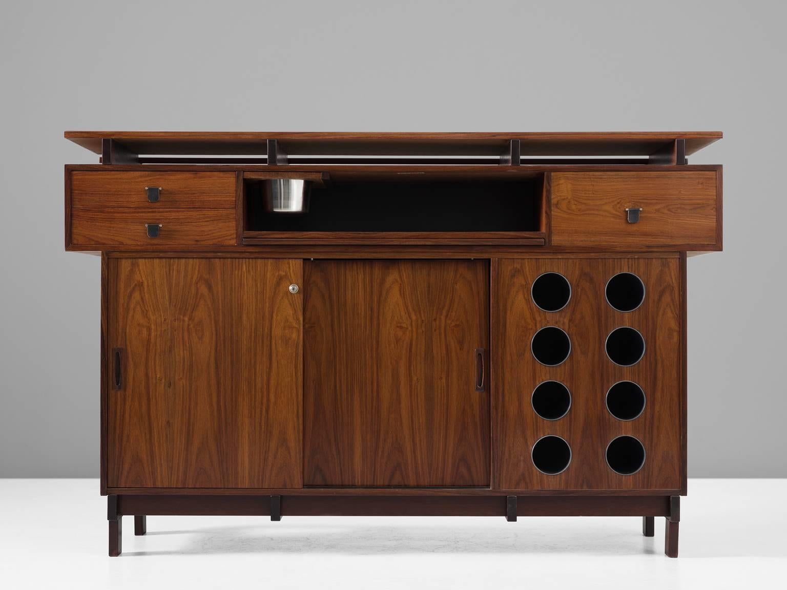 Bar cabinet, in rosewood, for Dyrlund, Denmark, 1960s. 

Well-crafted bar in rosewood, equipped with an ice holder and bottle holders. The beautiful warm rosewood grain is quite special. There are several drawers and spacious storage, which makes
