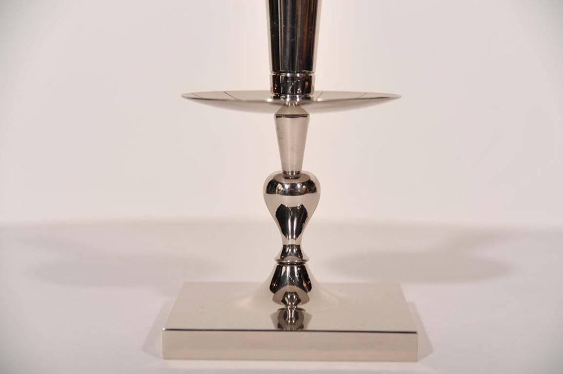 Pair of Mid-Century Classic candlesticks in polished nickel designed by Tommi Parzinger.