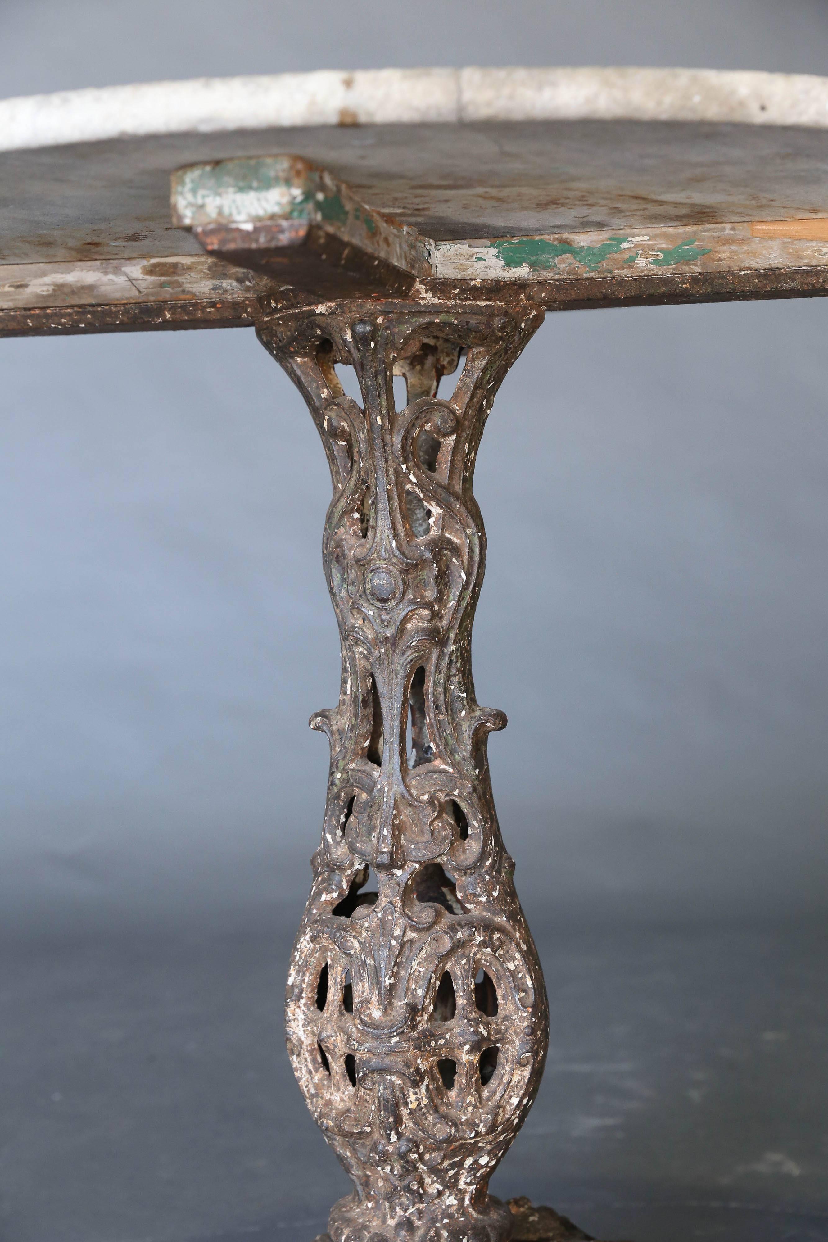 Cast Iron Base Bistro table with weathered marble top.