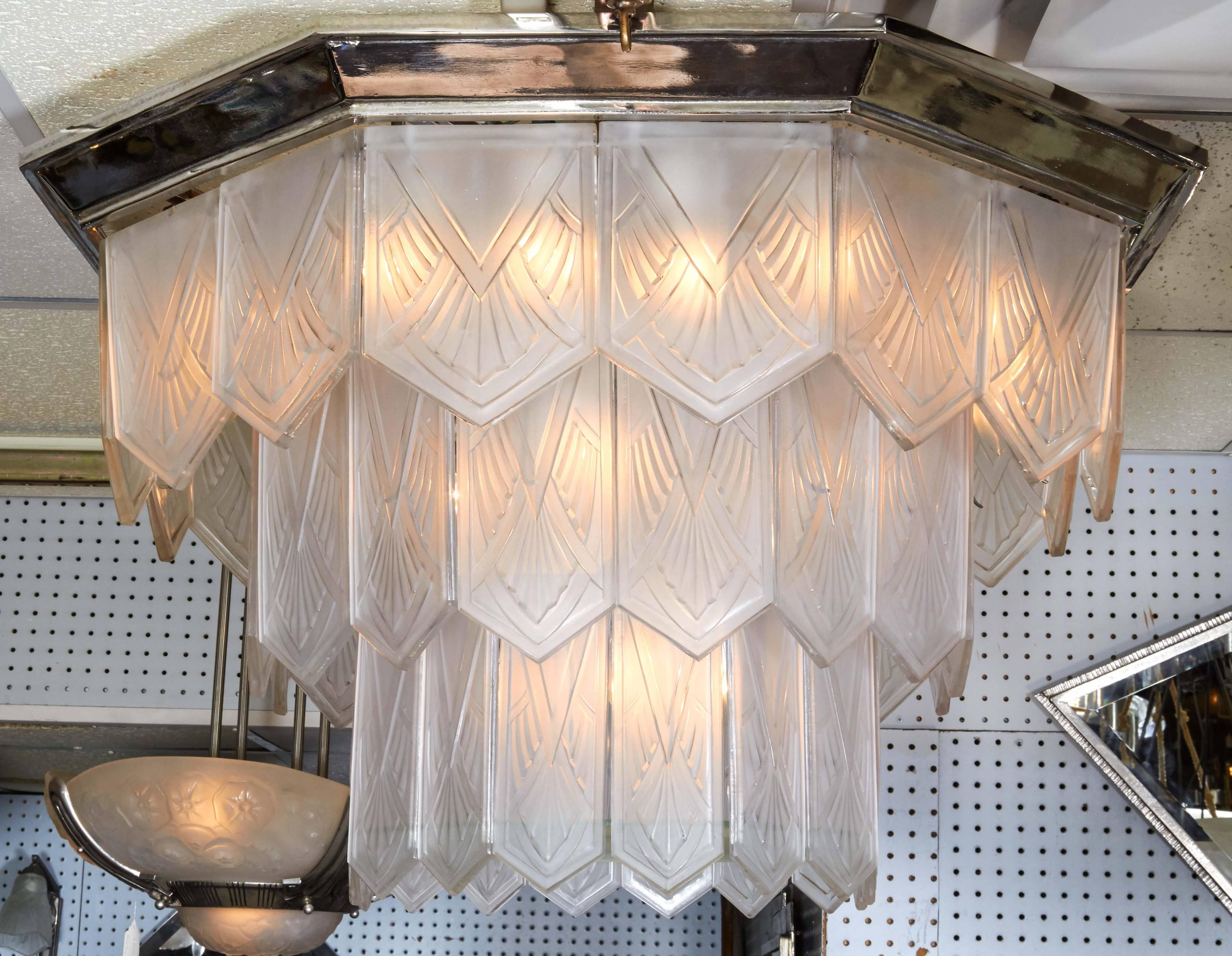 Enormous and spectacular French Art Deco chandelier by Sabino. Three tiers of varied size molded art glass panels in a waterfall design typifies this architecturally Modern looking chandelier. The cascading frosted and polished geometric patterned